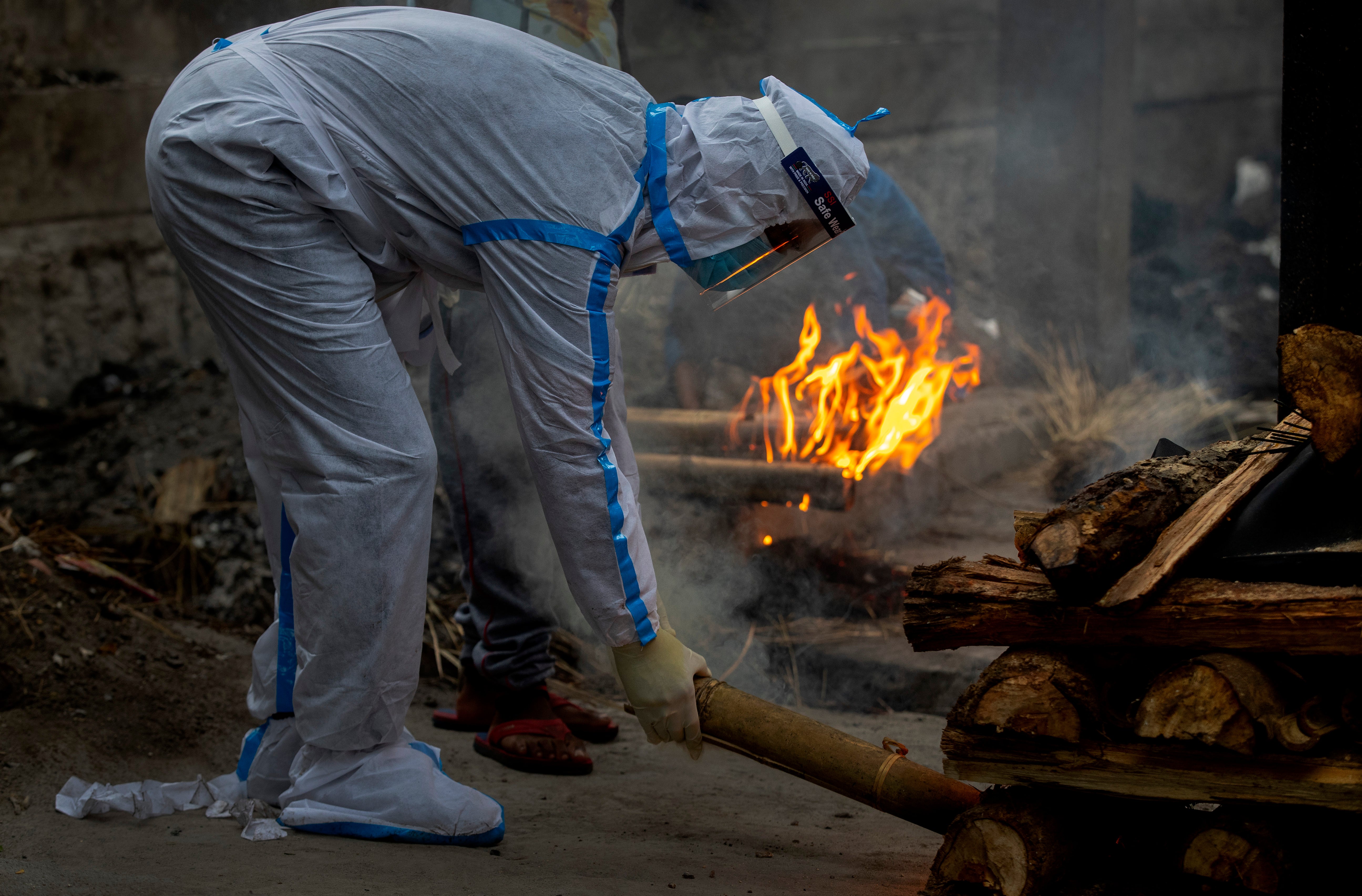 A relative lights the funeral pyre of a Covid-19 victim in India’s Guwahati city on 2 July 2021