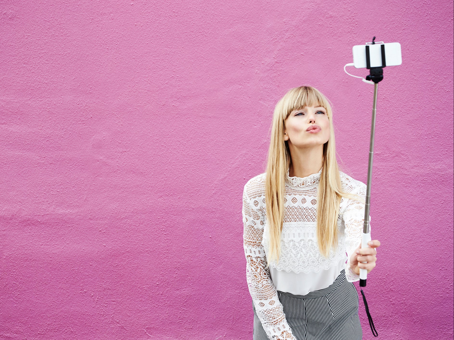 Influencers have flocked to a pink house in Cardiff to take pictures in front of it, says homeowner Eleri Morgan