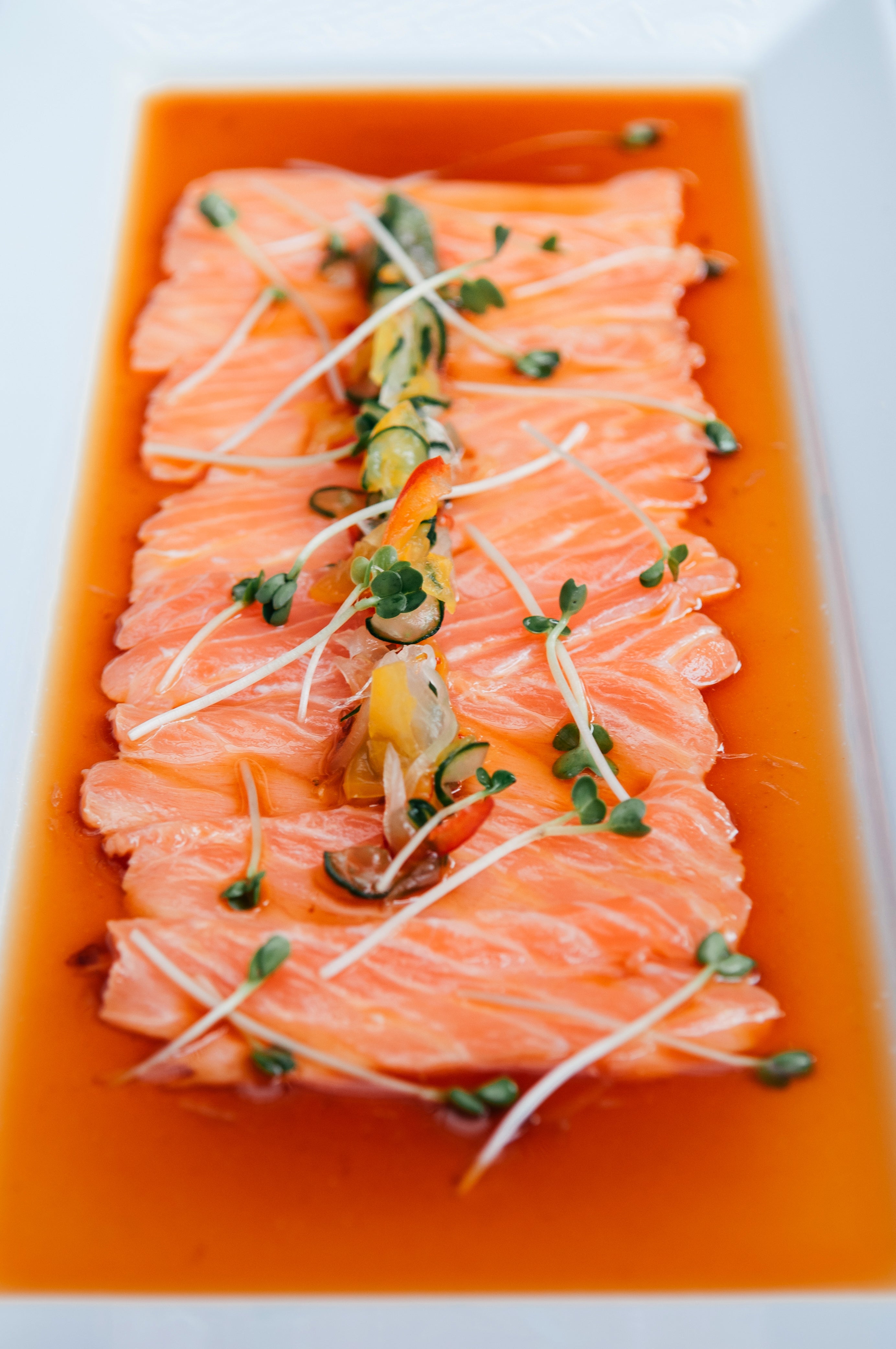 Fresh salmon tataki with homemade ponzu sauce and Kaiware sprouts