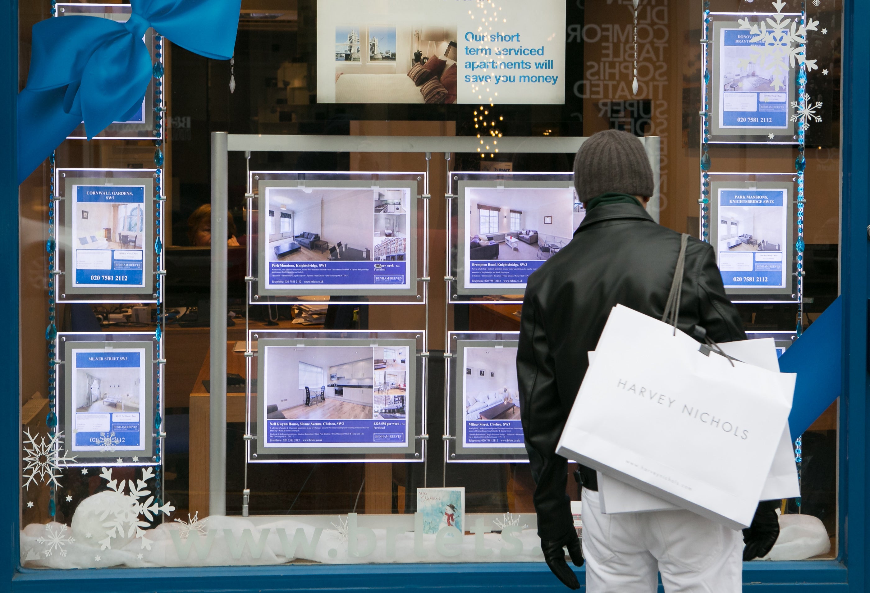 Someone looking in an estate agent's window