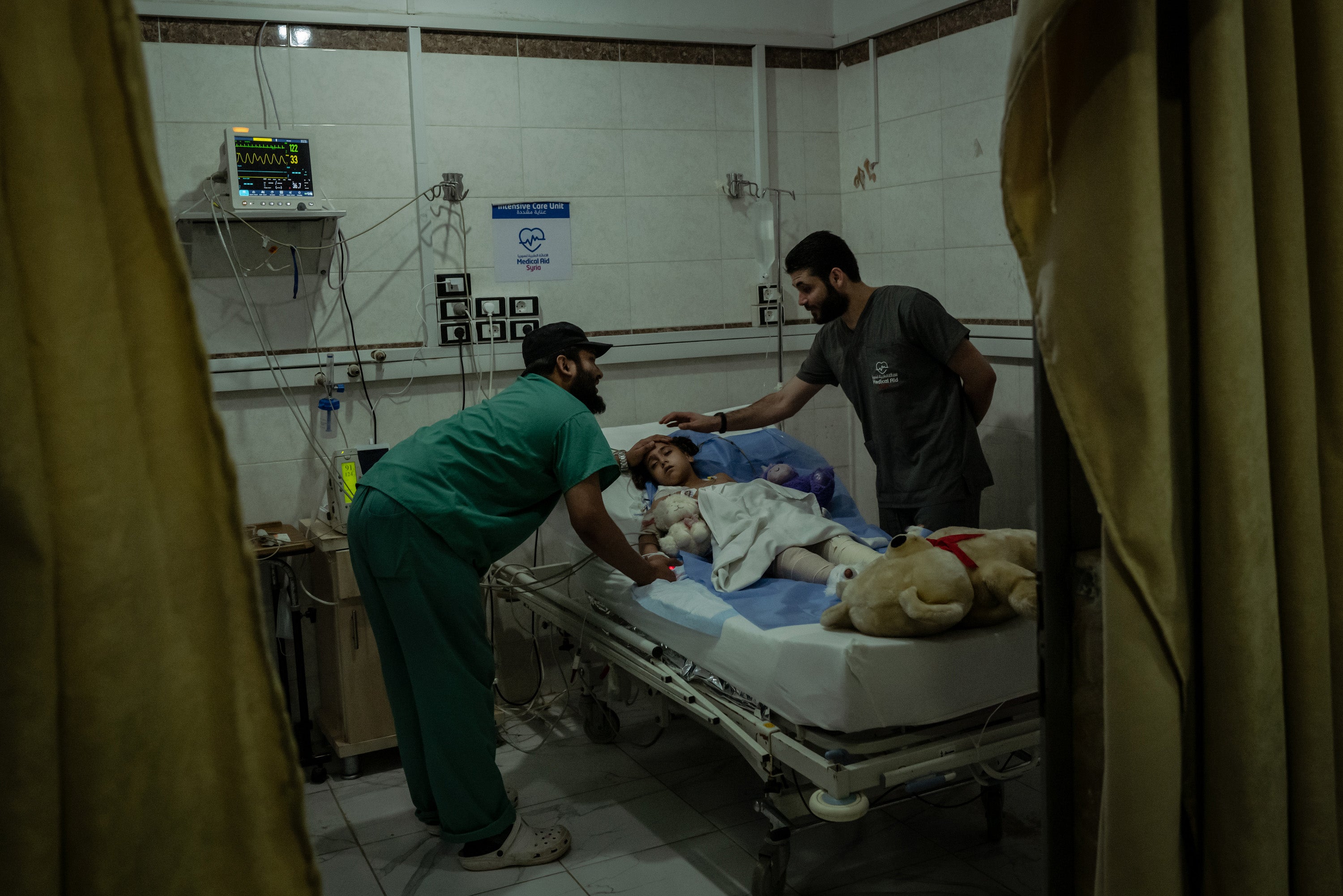 Doctors treat Bailasan Hindawi, 8, as she recovers in the intensive care unit at al-Shifa hospital in Idlib city earlier this month