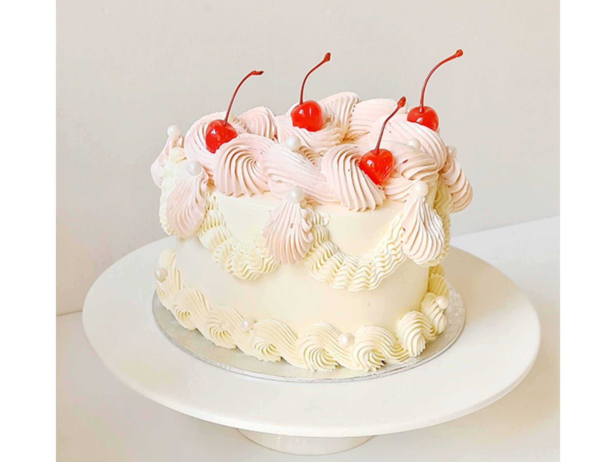 Lilly Vanilli heart cake with vanilla sponge, cherries and piping