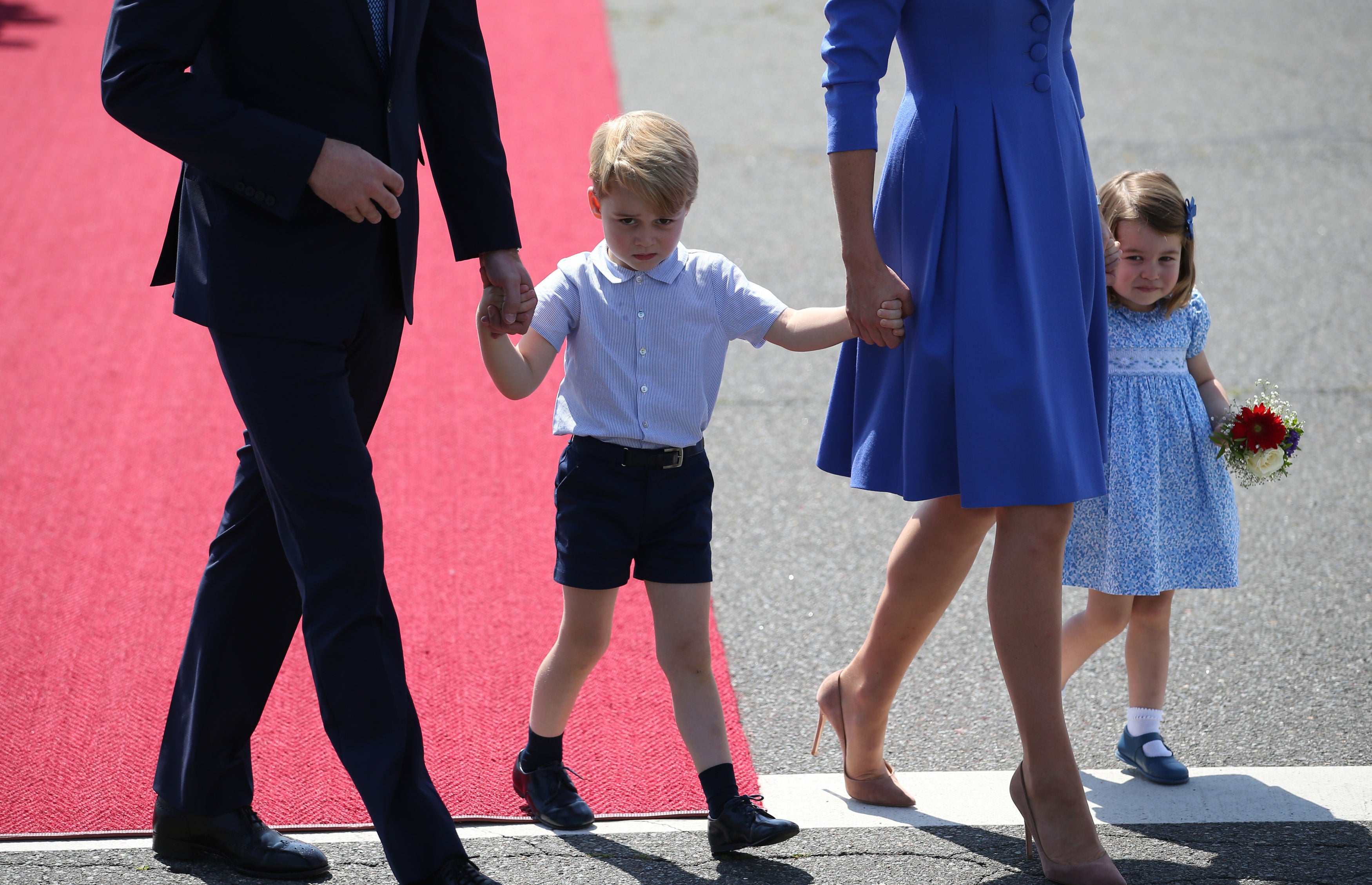 The Duke and Duchess of Cambridge with Prince George and Princess Charlotte at Berlin Airport (Jane Barlow/PA)