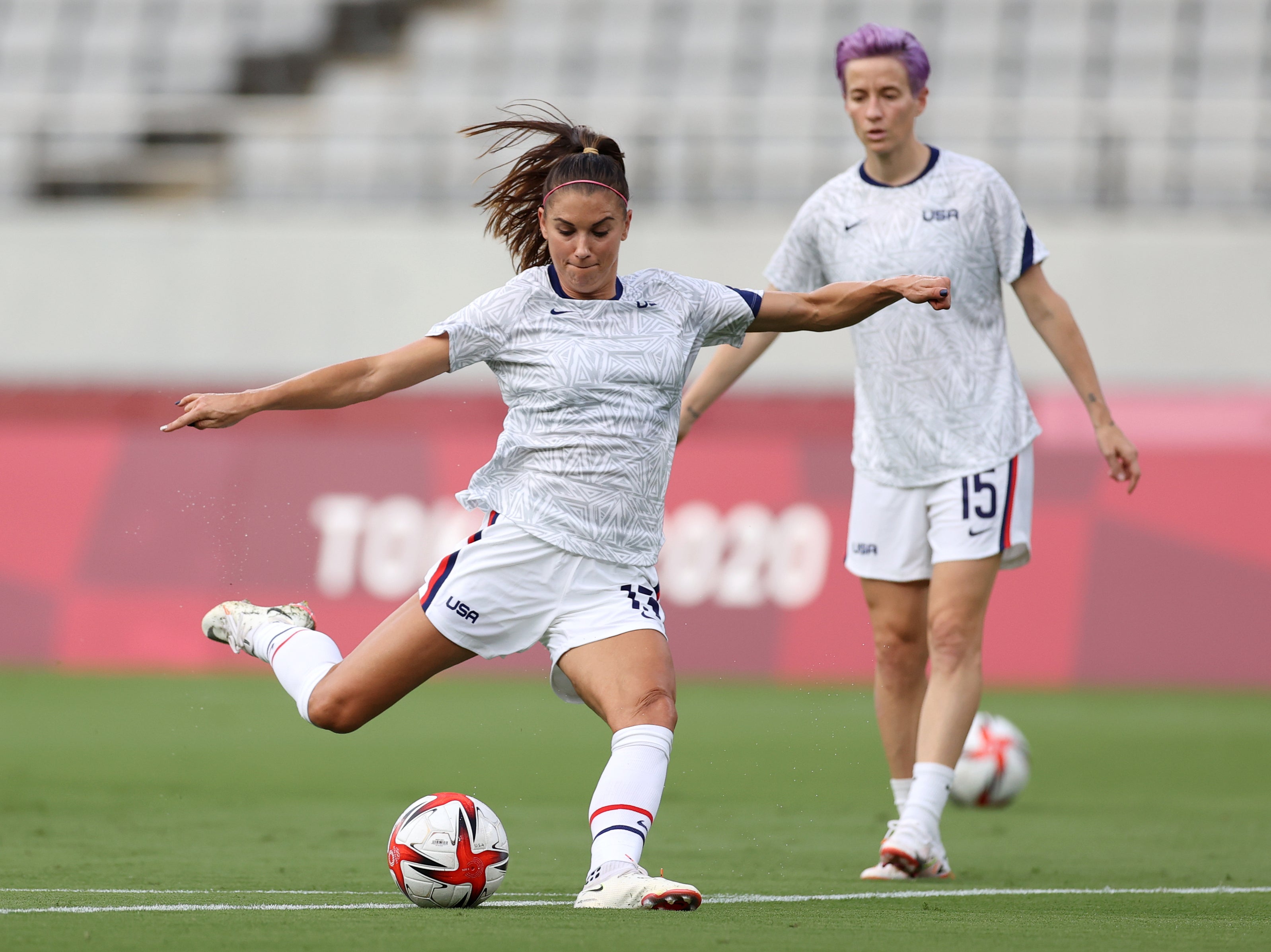 <p>Alex Morgan and Megan Rapinoe warming up in Chofu, Japan</p>