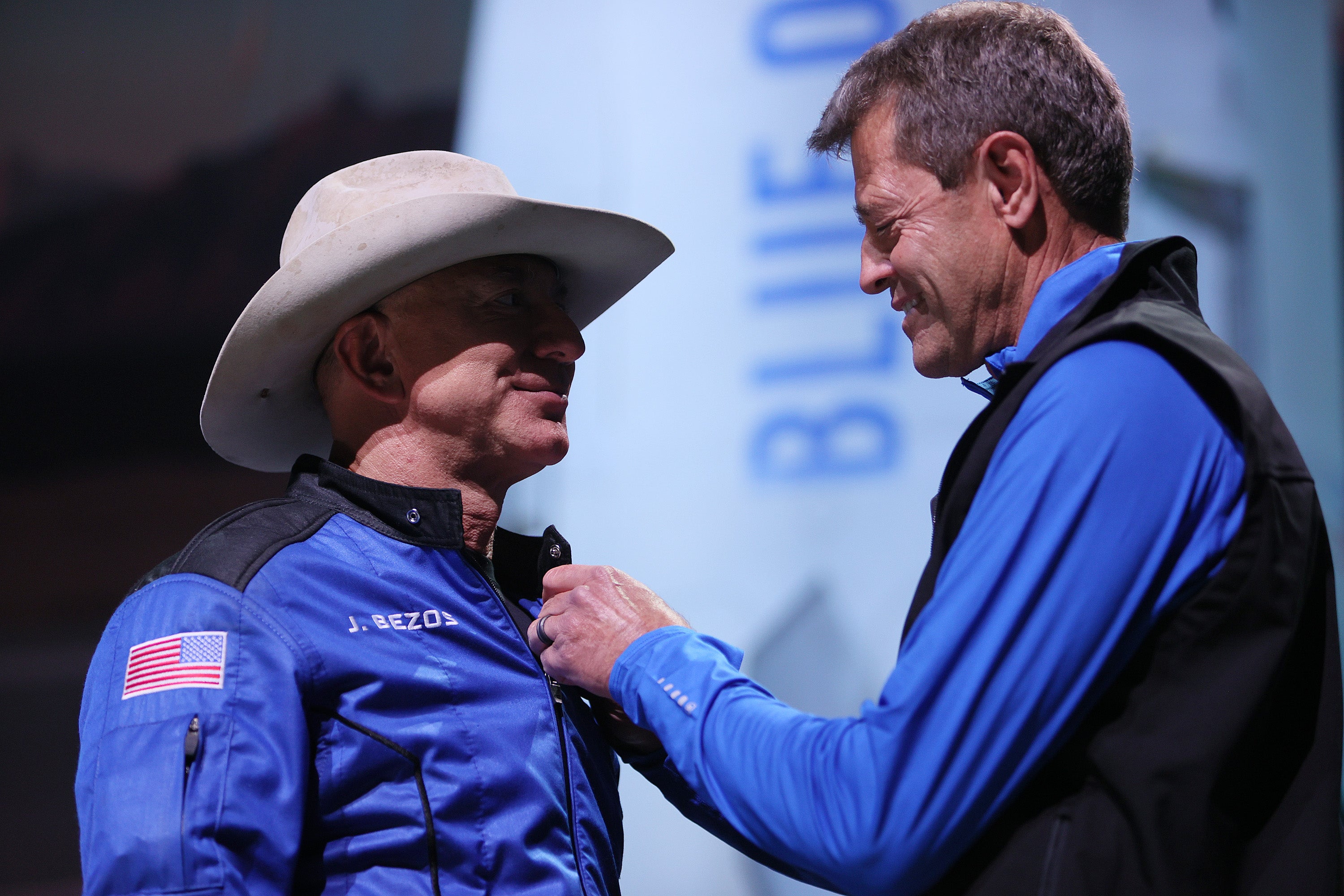 Jeff Bezos receives astronaut wings from Blue Origin’s Jeff Ashby, a former Space Shuttle commander