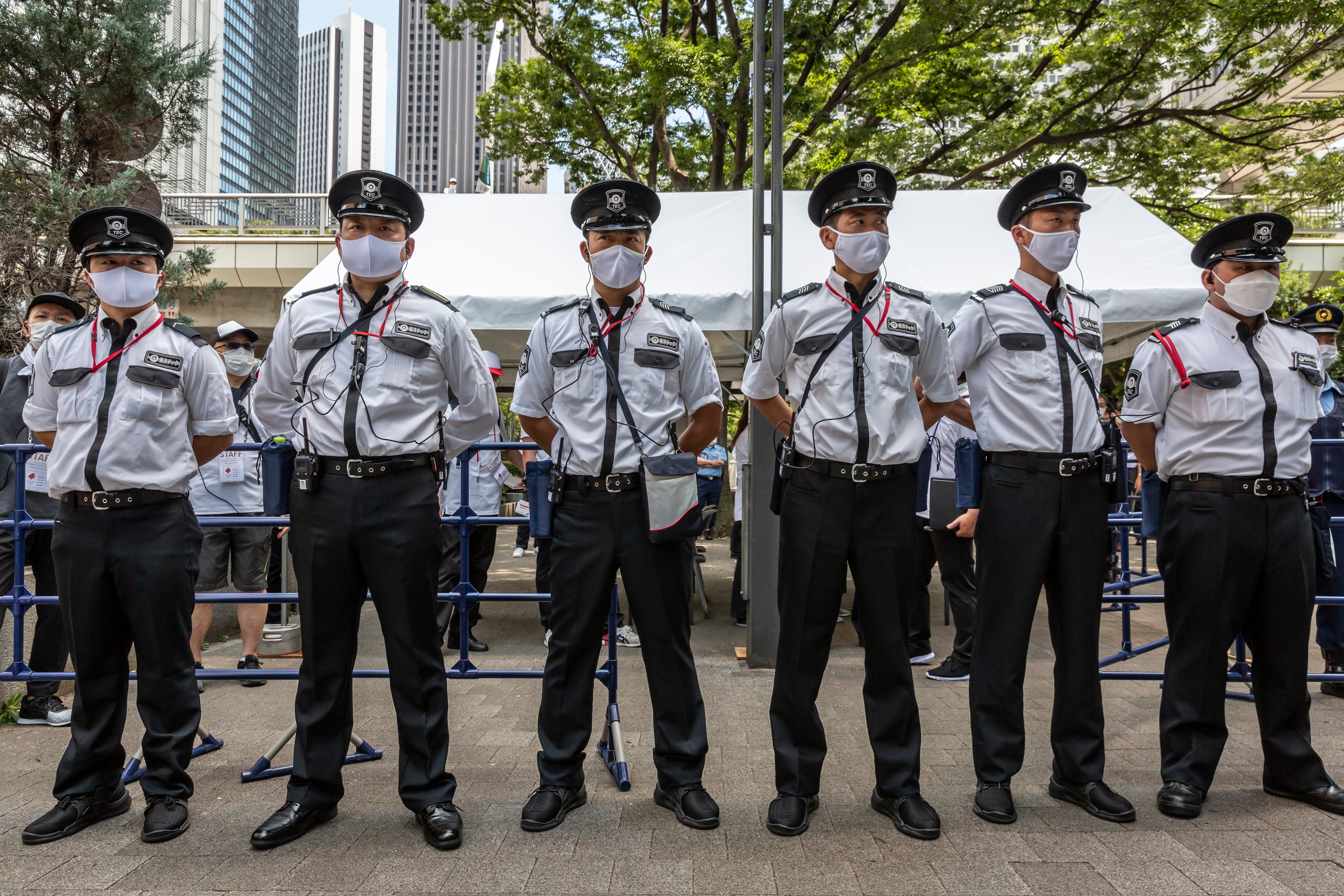 Security guards protect the Olympic Torch Relay Celebration event venue