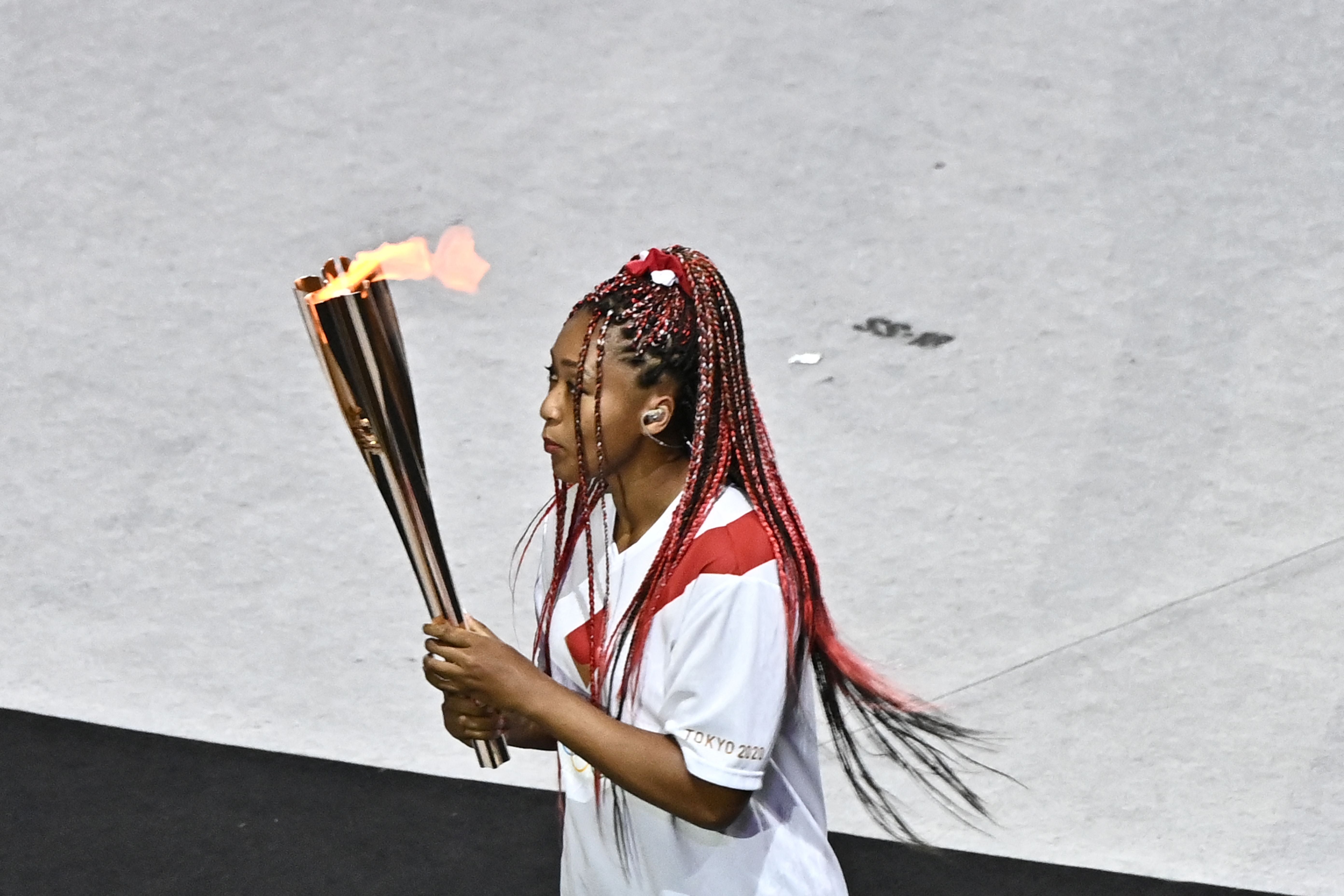 Naomi Osaka carries the Olympic torch