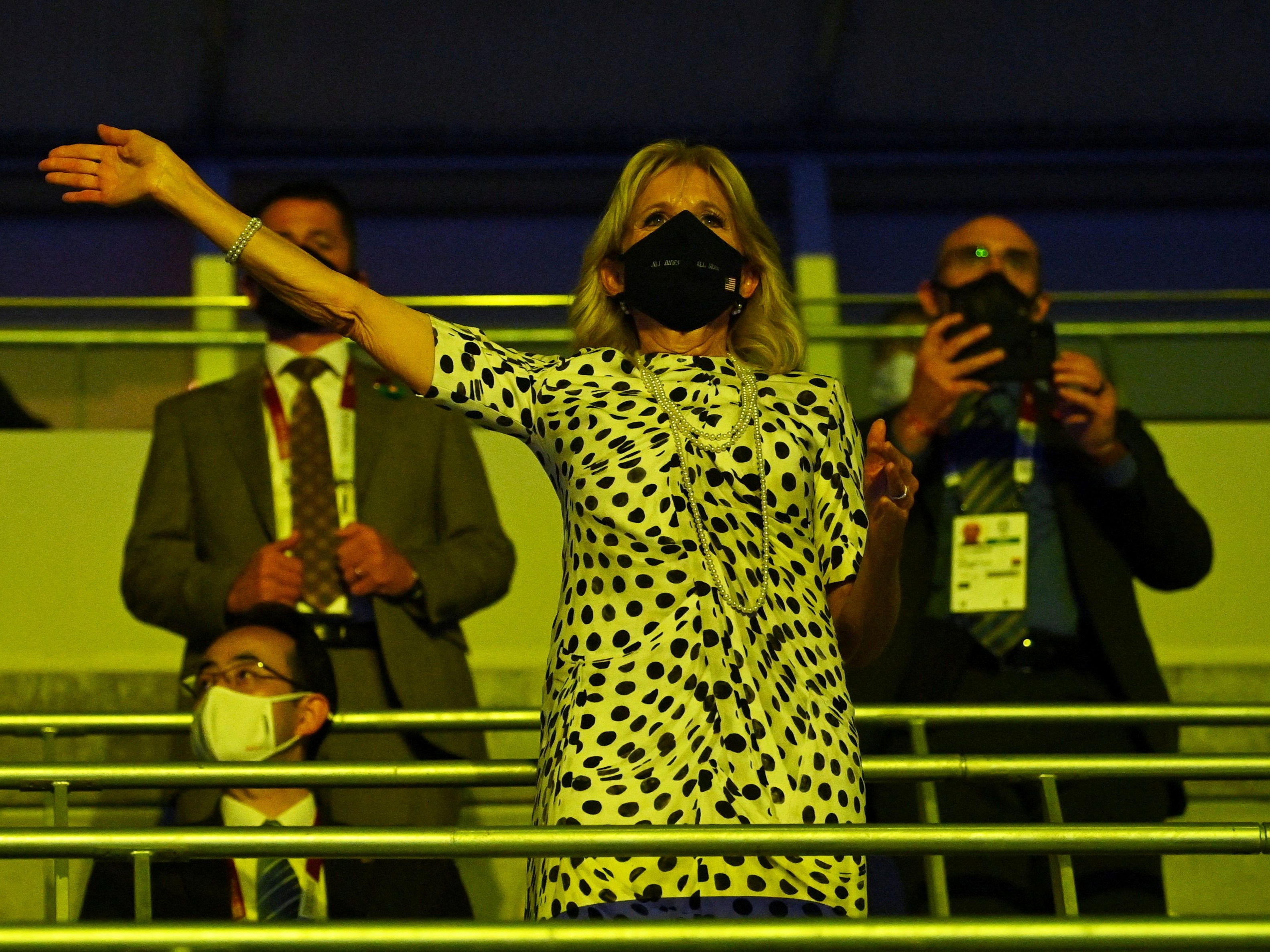 First Lady Jill Biden wearing a protective face mask reacts as the U.S. contingent enters the stadium during the opening ceremony.