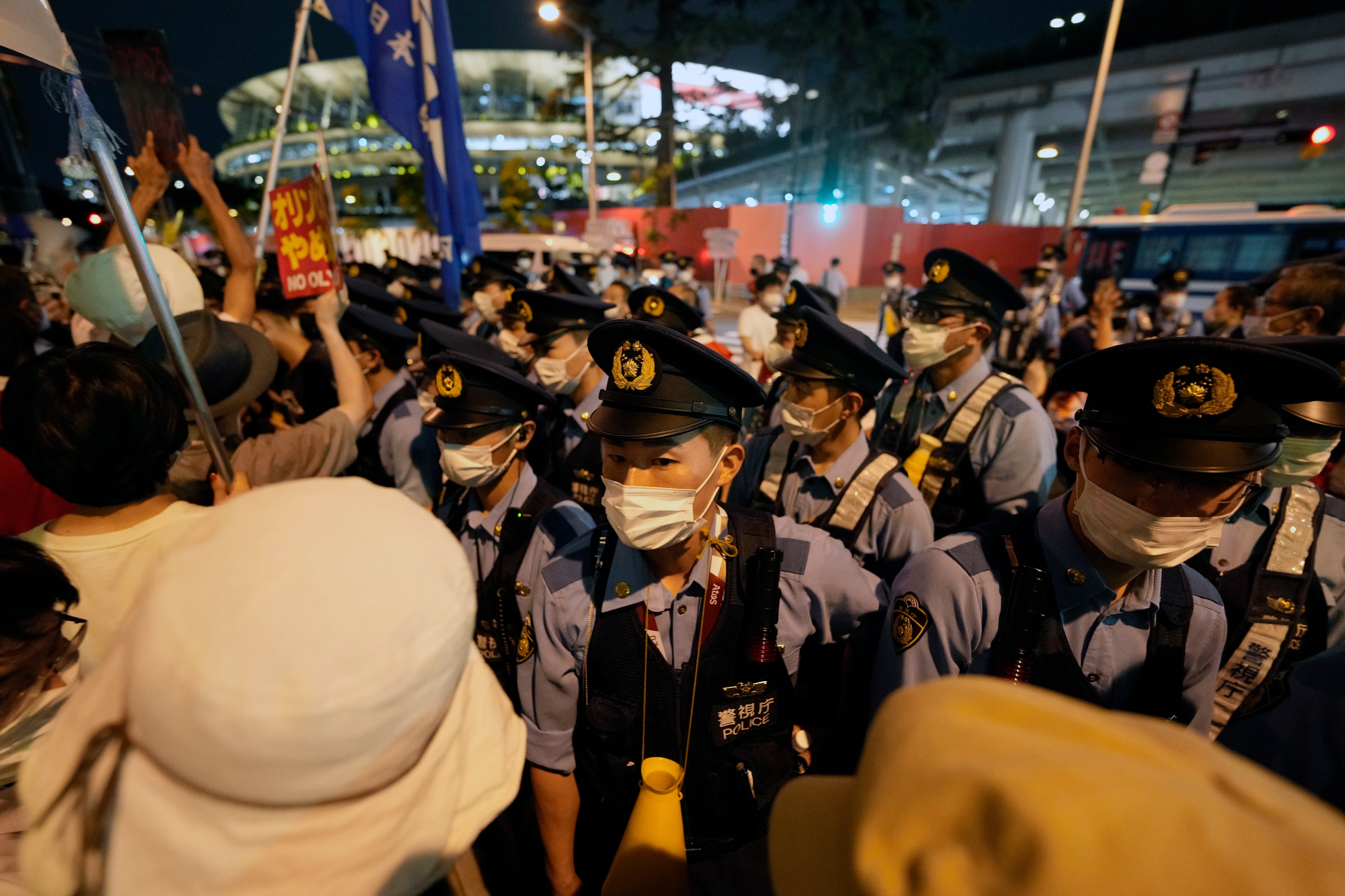 People stage a protest before the National Stadium during the opening ceremony of the Tokyo 2020 Games