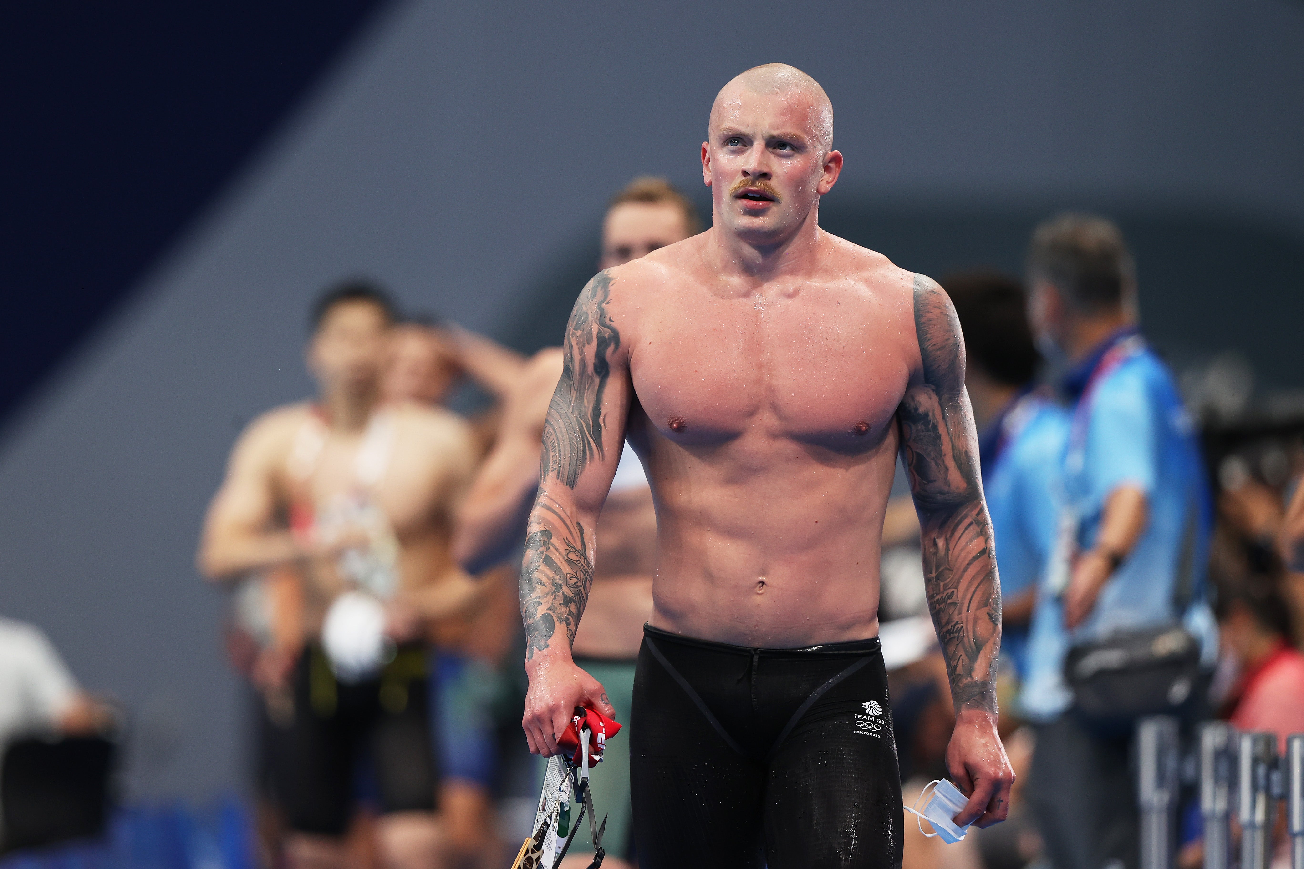 Adam Peaty walks away after winning his heat