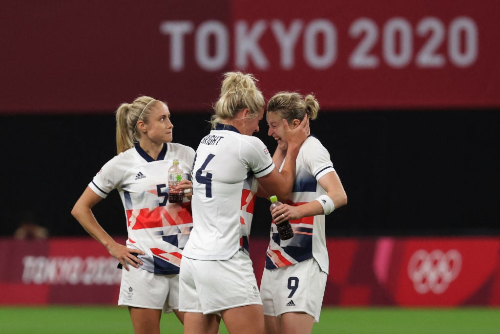 Britain's forward Ellen White (R) celebrates with teammates after Britain won the Tokyo 2020 Olympic Games women's group E first round football match between Japan and Britain at the Sapporo Dome in Sapporo on July 24, 2021