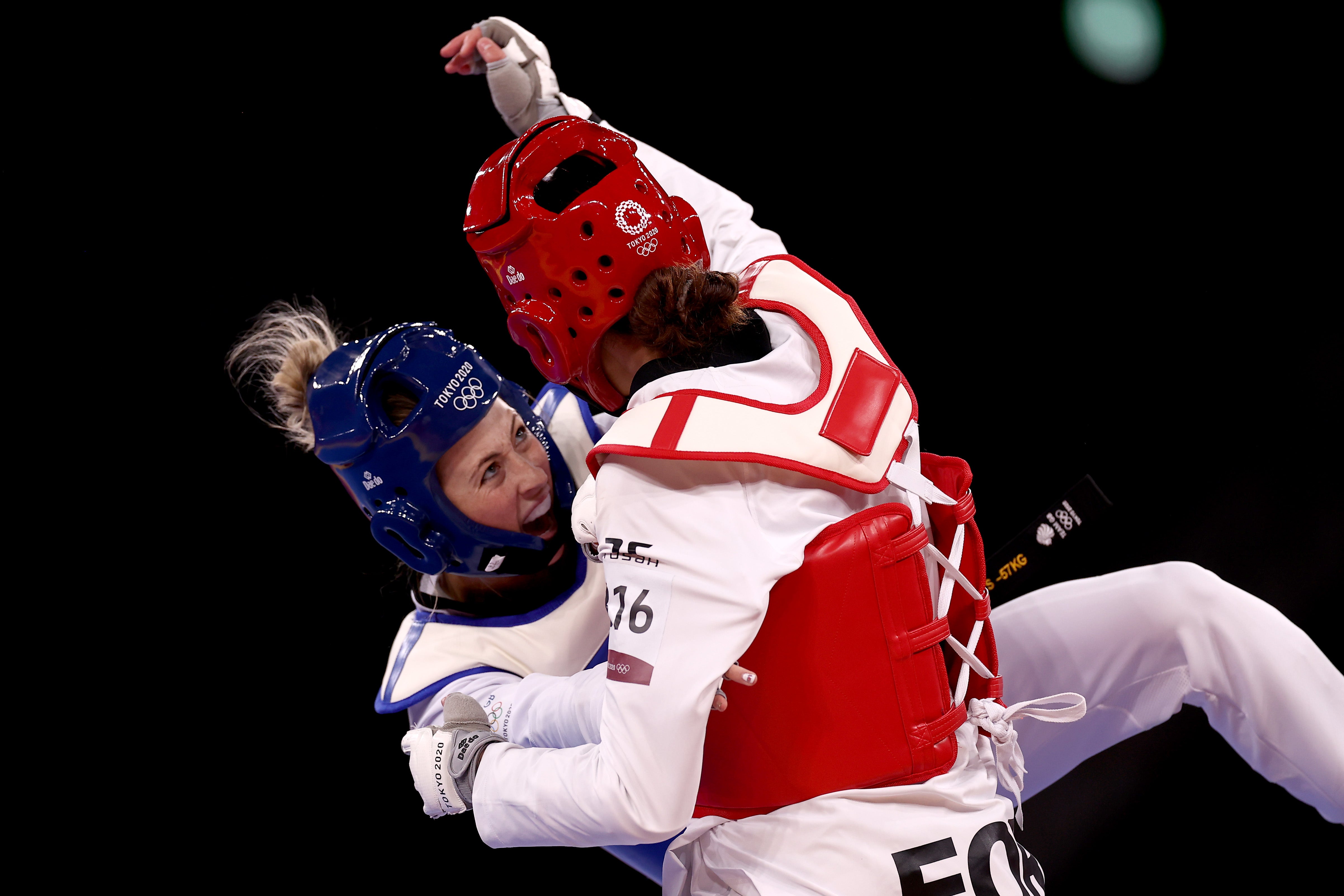 Jade Jones (L) of Team Great Britain competes against Kimia Alizadeh Zonouzi of IOC Refugee Team during the Women's -57kg Taekwondo Round of 16 contest on day two of the Tokyo 2020 Olympic Games at Makuhari Messe Hall on 25 July 2021 in Chiba, Japan