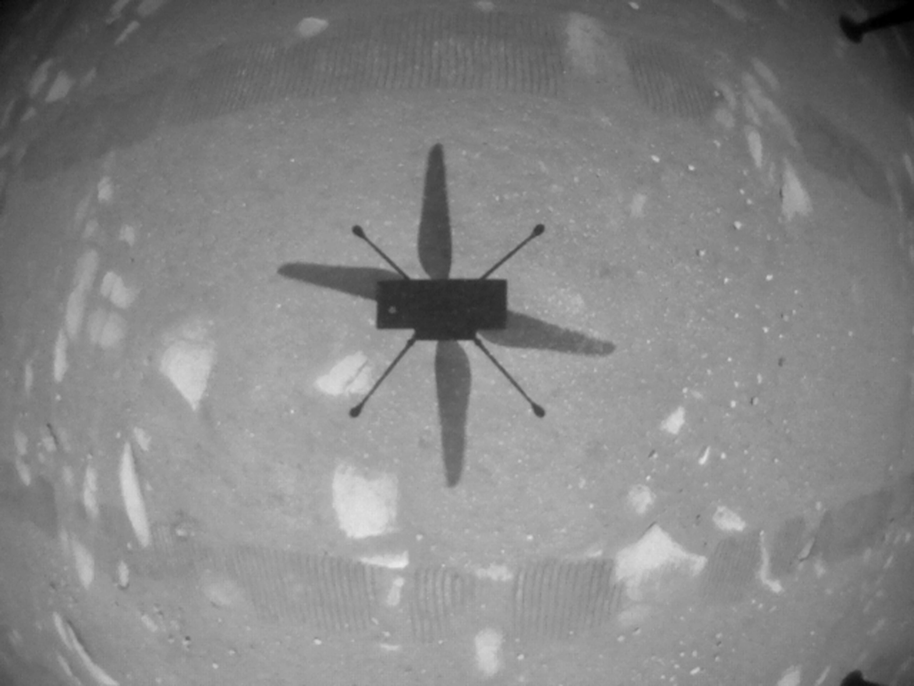 NASA’s Ingenuity Mars Helicopter took this shot while hovering over the Martian surface on April 19, 2021, during the first instance of powered, controlled flight on another planet