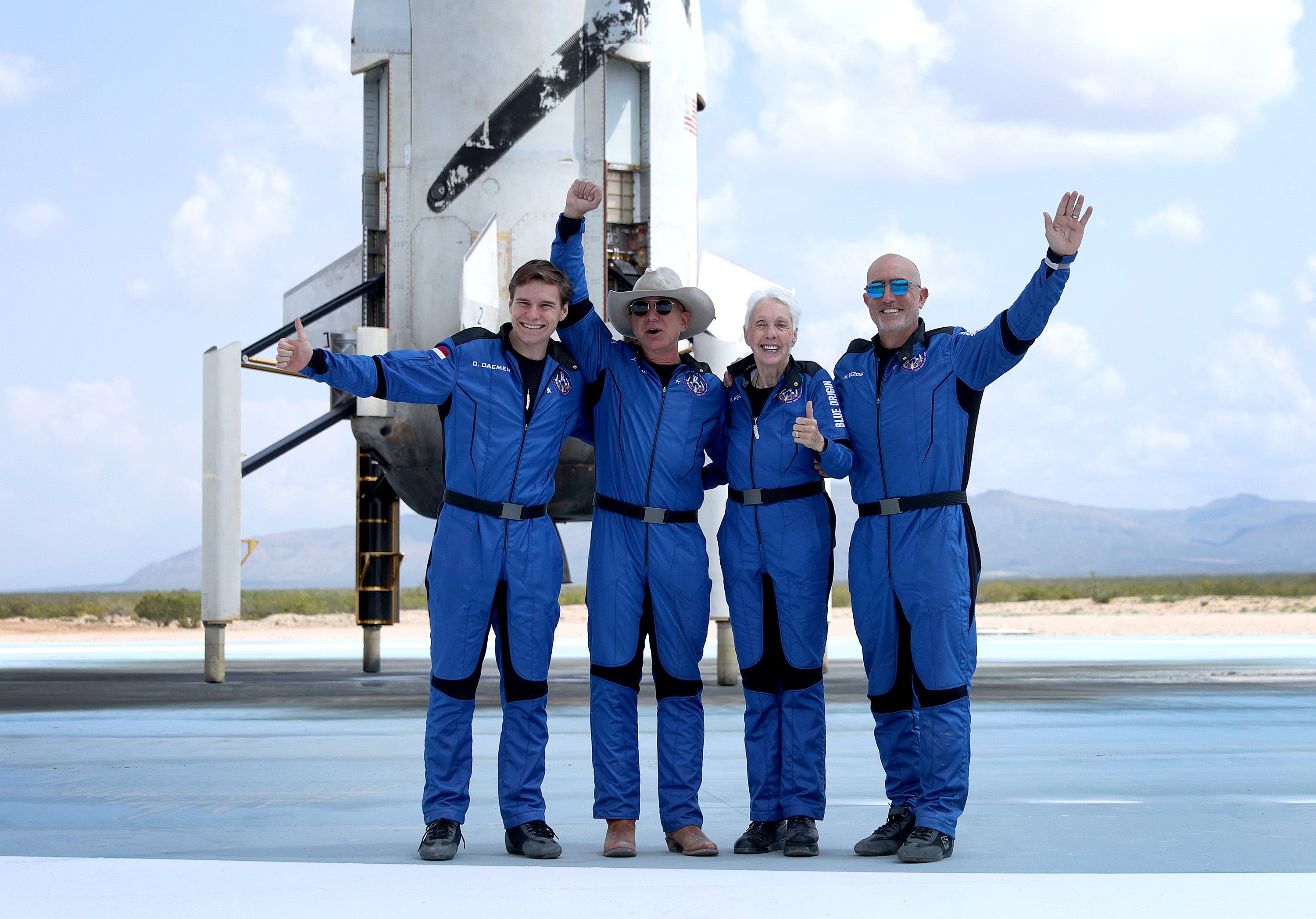 Blue Origin’s New Shepard crew (L-R) Oliver Daemen, Jeff Bezos, Wally Funk and Mark Bezos pose for a picture after flying into space in the Blue Origin New Shepard in Van Horn, Texas