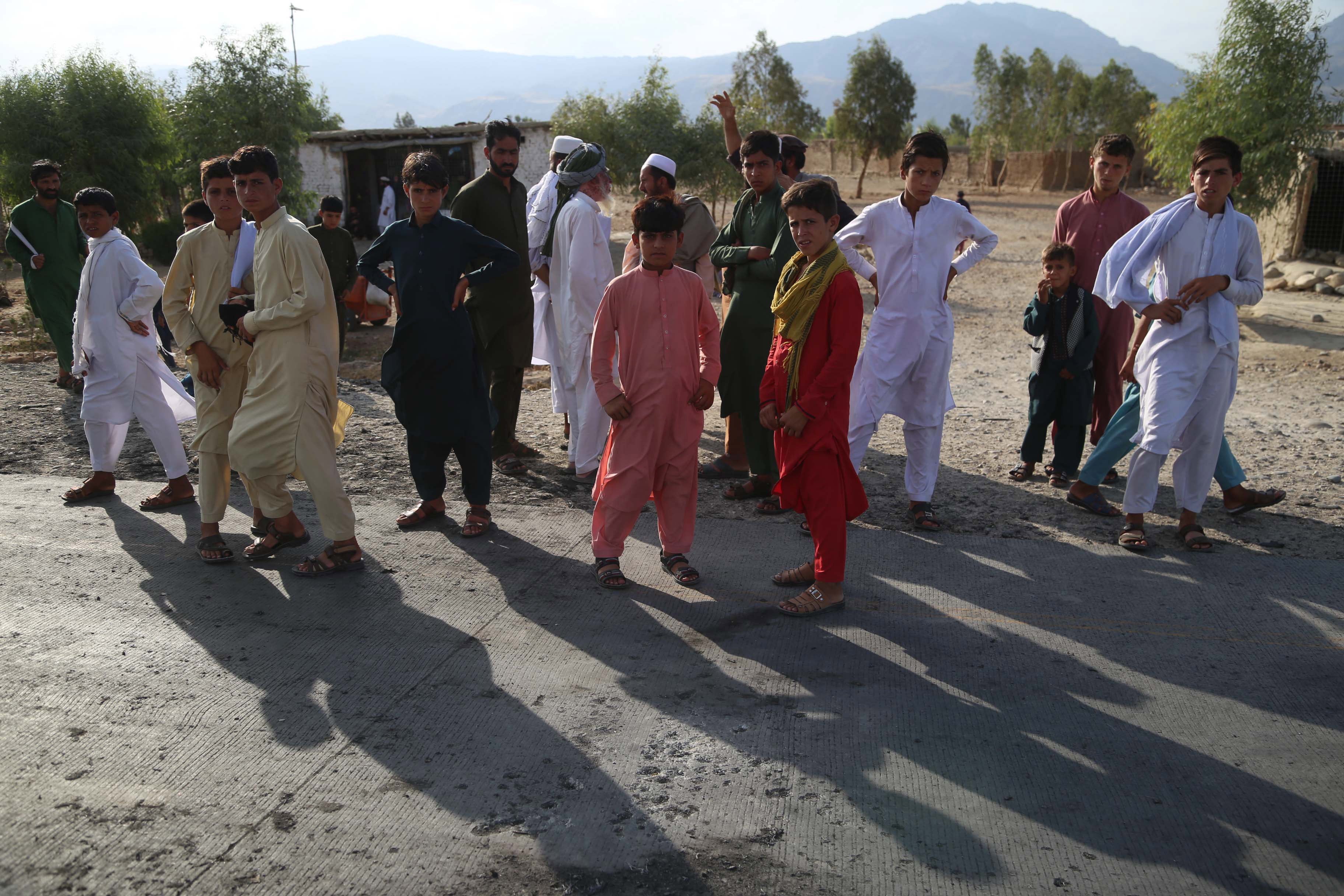 Afghans gather at the scene of the blast