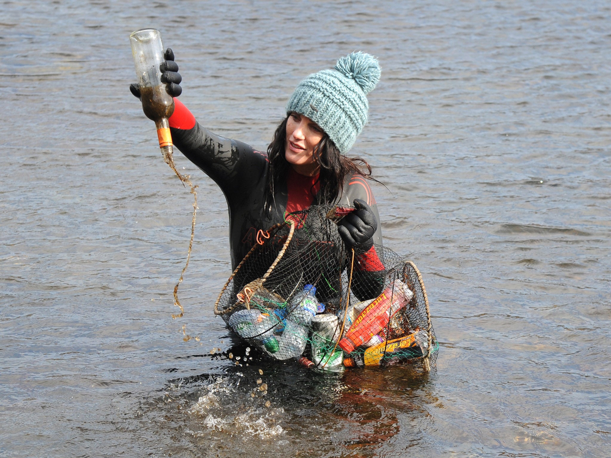 Surfers Against Sewage activist Laura Sanderson collects debris in Afon Glaslyn river in Snowdonia to highlight the issue of plastic pollution