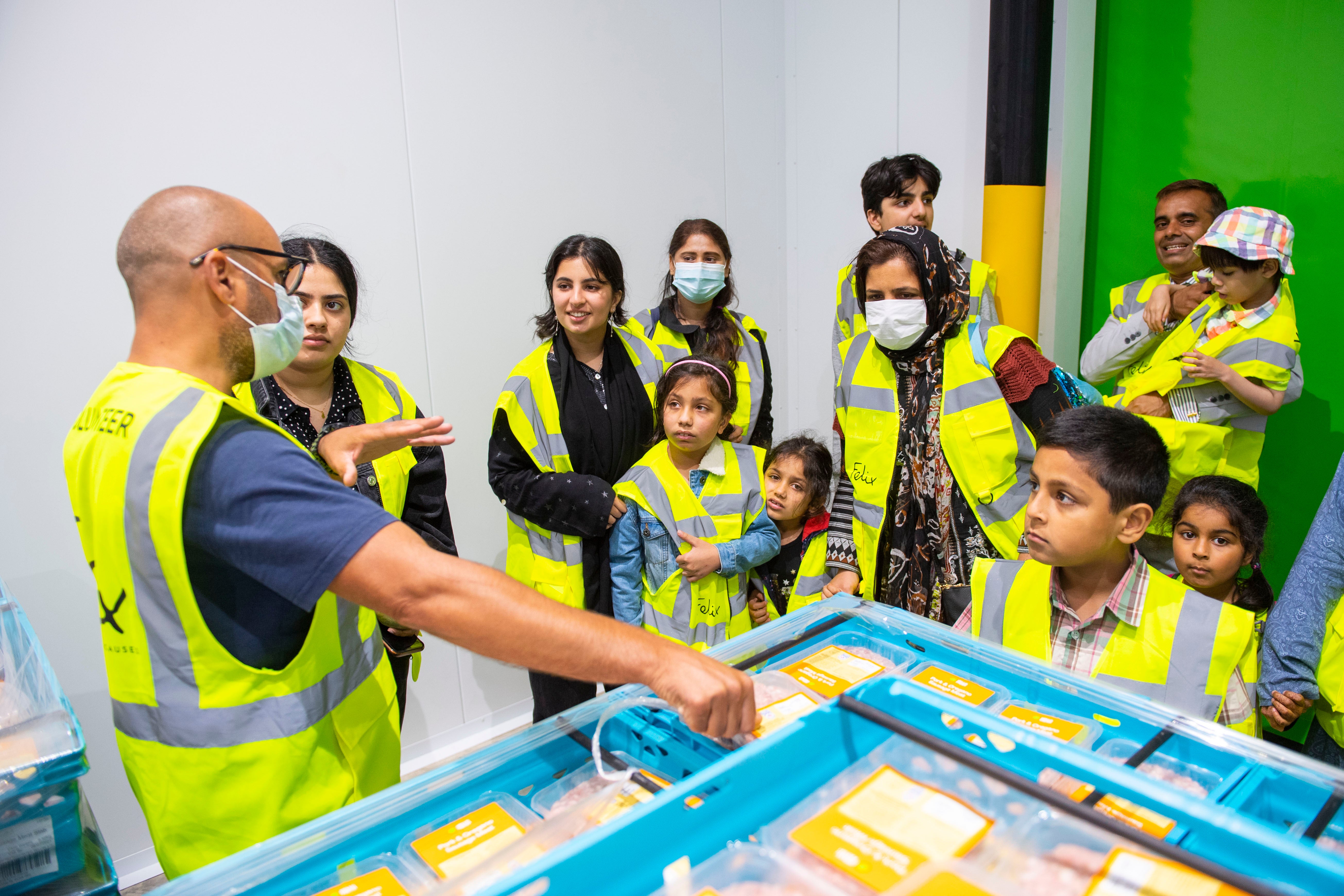 Local children are shown around the centre