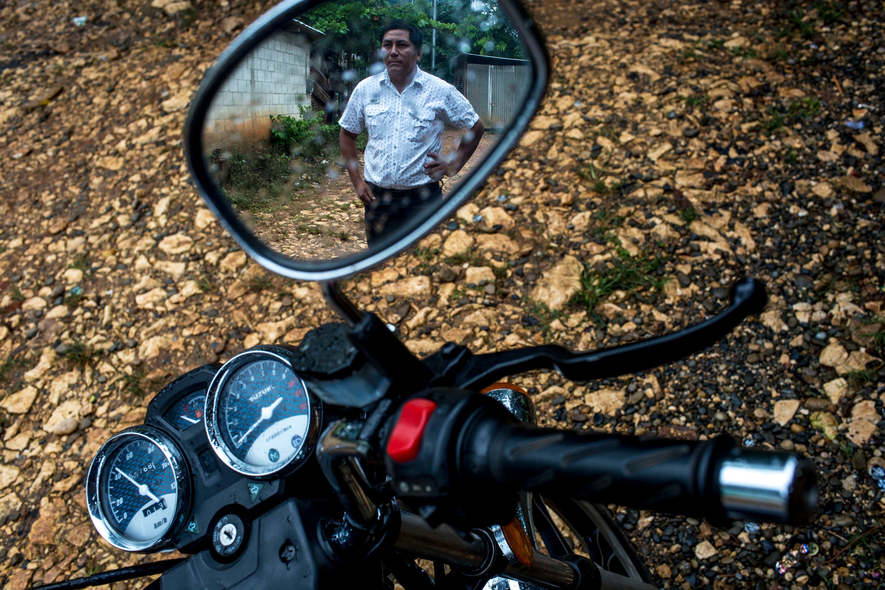 Eriberto Pop prepares to leave his house on a rented motorbike to look for separated parents in four cases he is handling