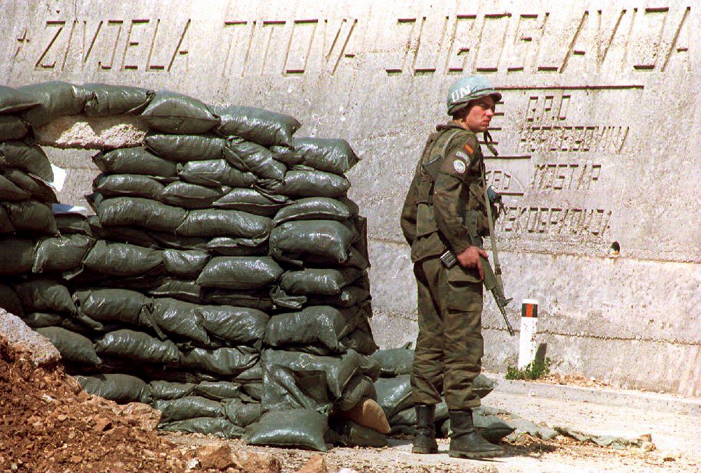 A Spanish UN Protection Force soldier based in Medjugorje guards a road a few kilometers north of Mostar, next to an inscription reading ‘Long Live Tito's Yugoslavia’, 29 March 1994