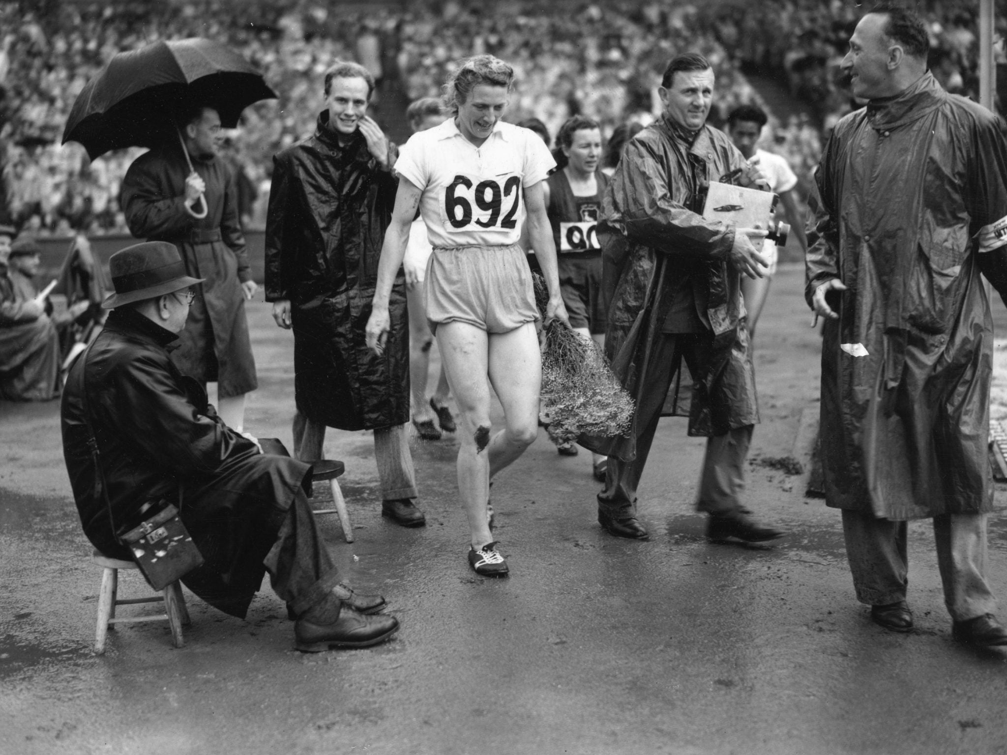 Blankers-Koen leaving the track at Wembley Stadium after winning 200m gold