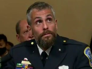 Capitol Police Officer Michael Fanone watches footage of the 6 January insurrection during the House select committee hearing on the Capitol riot.