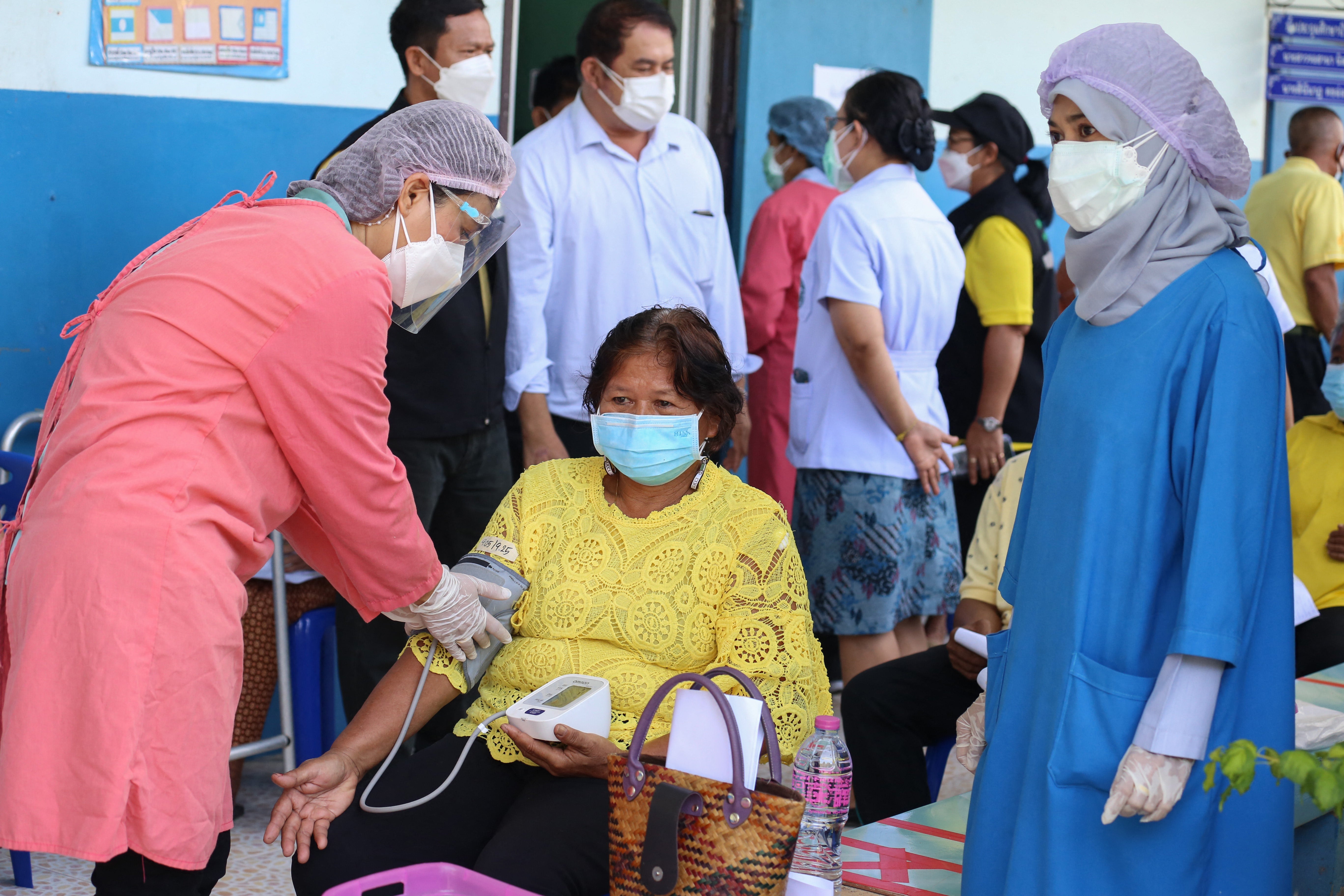 A woman gets her blood pressure checked as officials at Khok Pho Hospital prepare to administer the AstraZeneca vaccine for Covid-19 to some 200 people