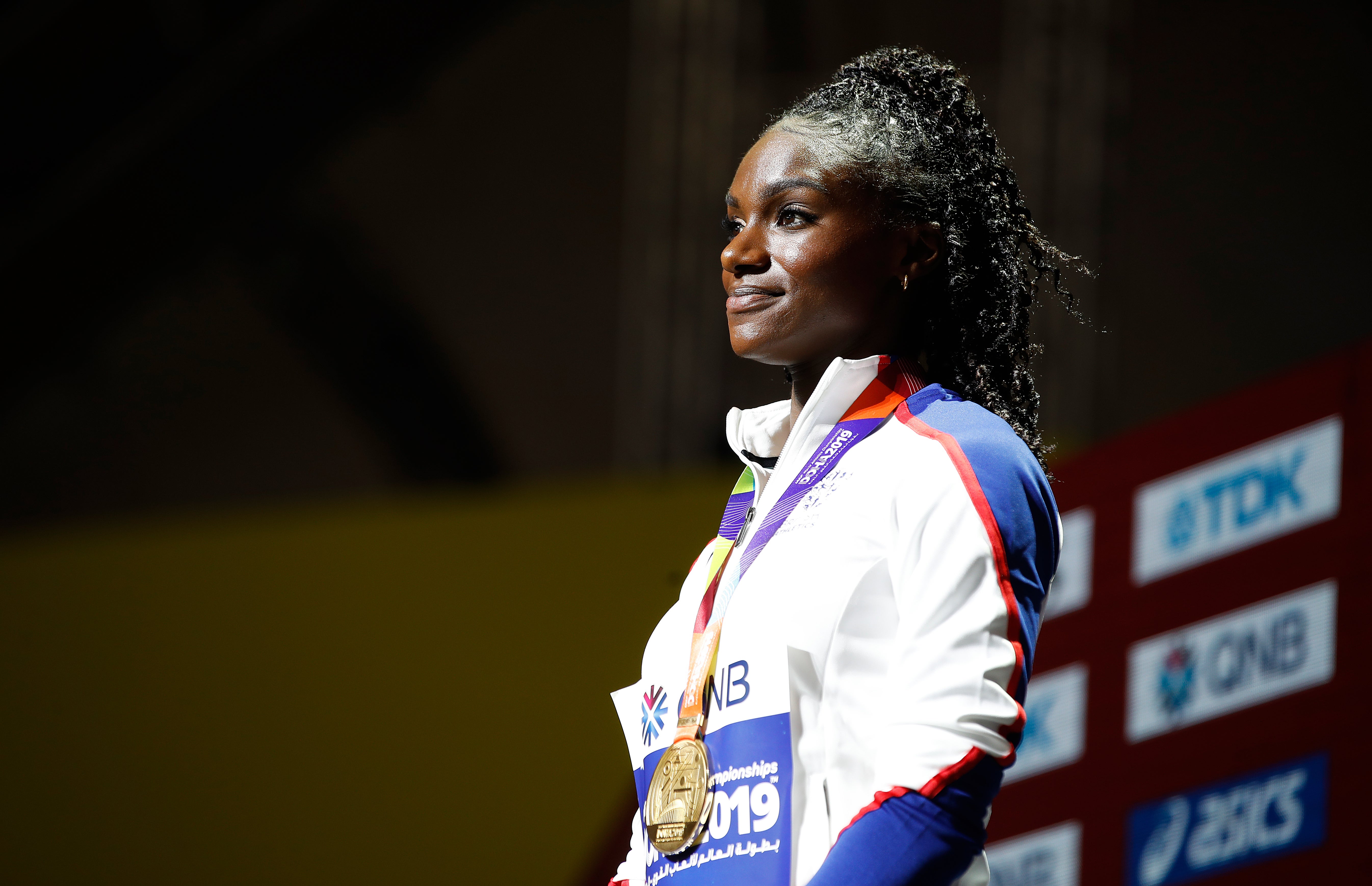 Dina Asher-Smith on the podium after receiving her 200m gold medal at the 2019 World Championships in Doha (Martin Rickett/PA)