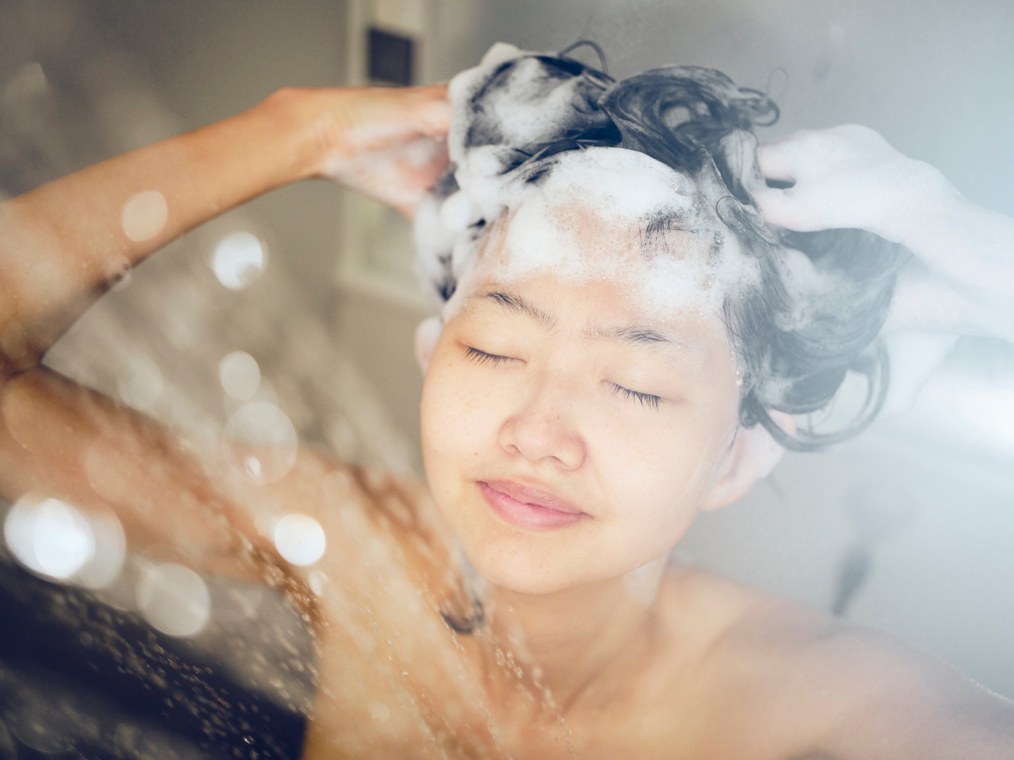 A woman washing her hair at home.