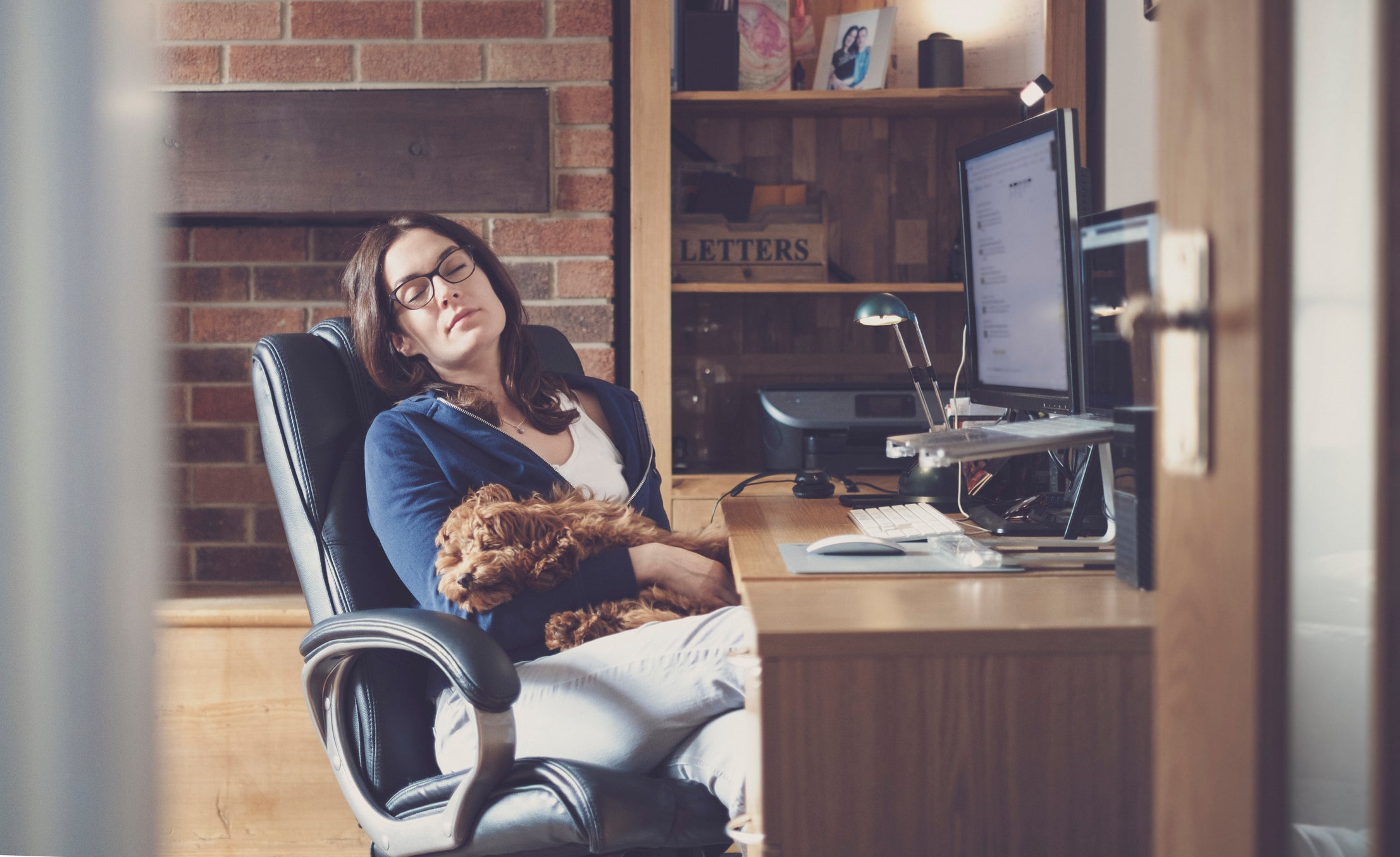 A woman relaxing while at her remote working station.