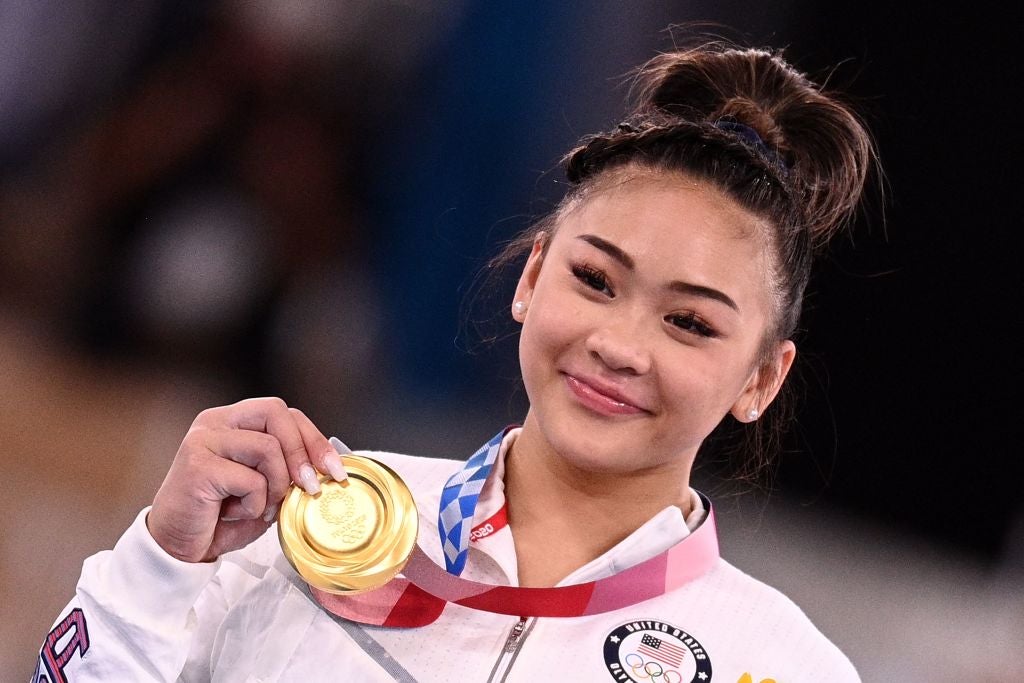 Sunisa Lee celebrates with her gold medal