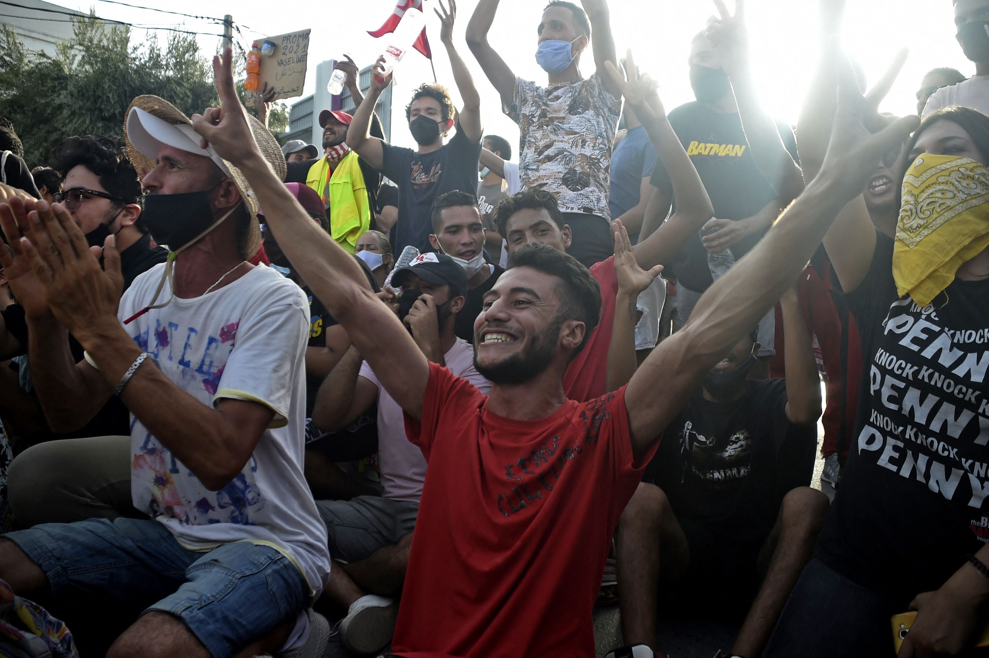 Supporters cheer outside parliament in Tunis after the president dismissed the prime minister