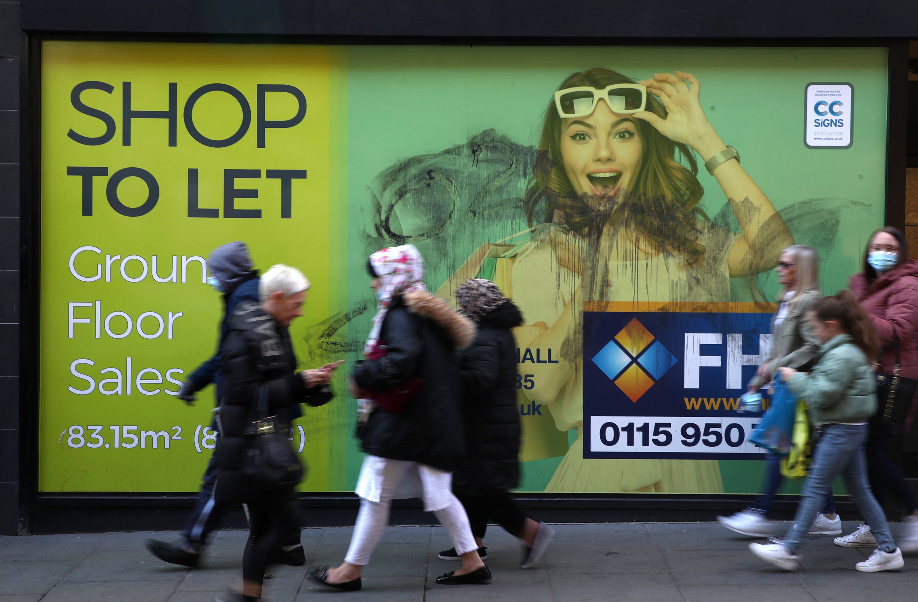 Shoppers walk past a closed down shop in Nottingham (Tim Goode/PA)