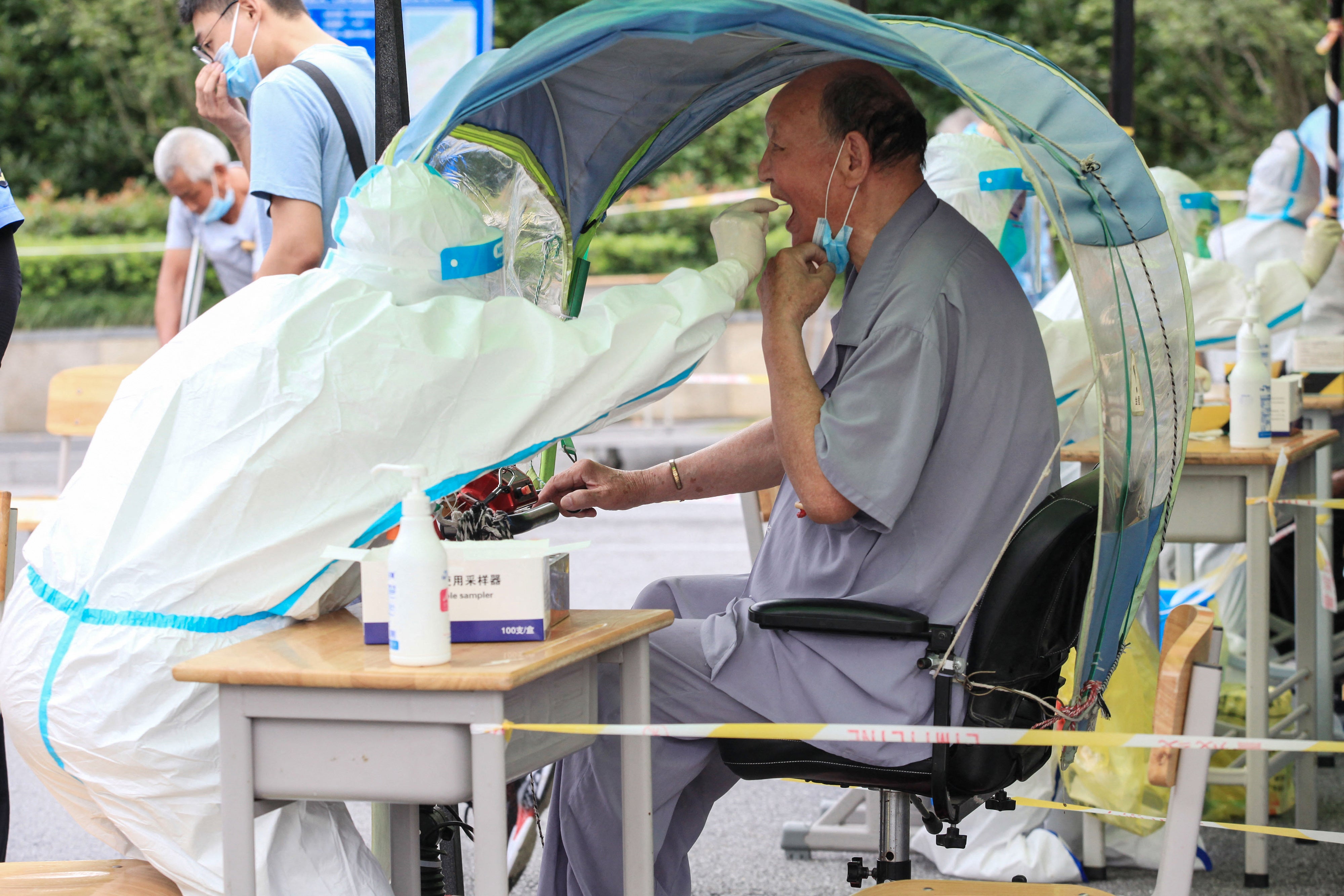 File: An elderly man receives a nucleic acid test for the Covid-19 coronavirus in Nanjing in eastern Jiangsu province