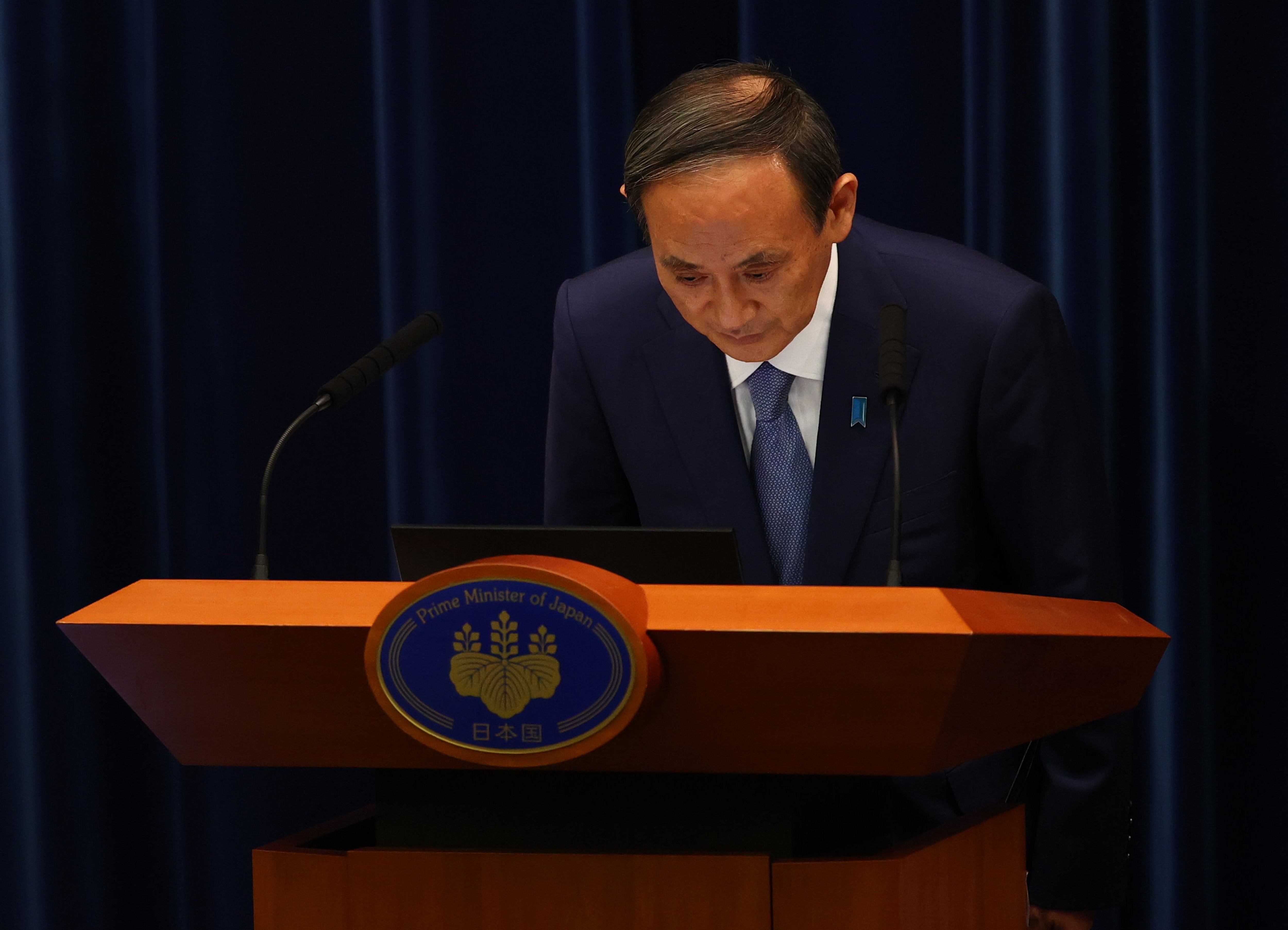 Japan's prime minister Yoshihide Suga bows as he attends a news conference on Japan's response to the coronavirus pandemic