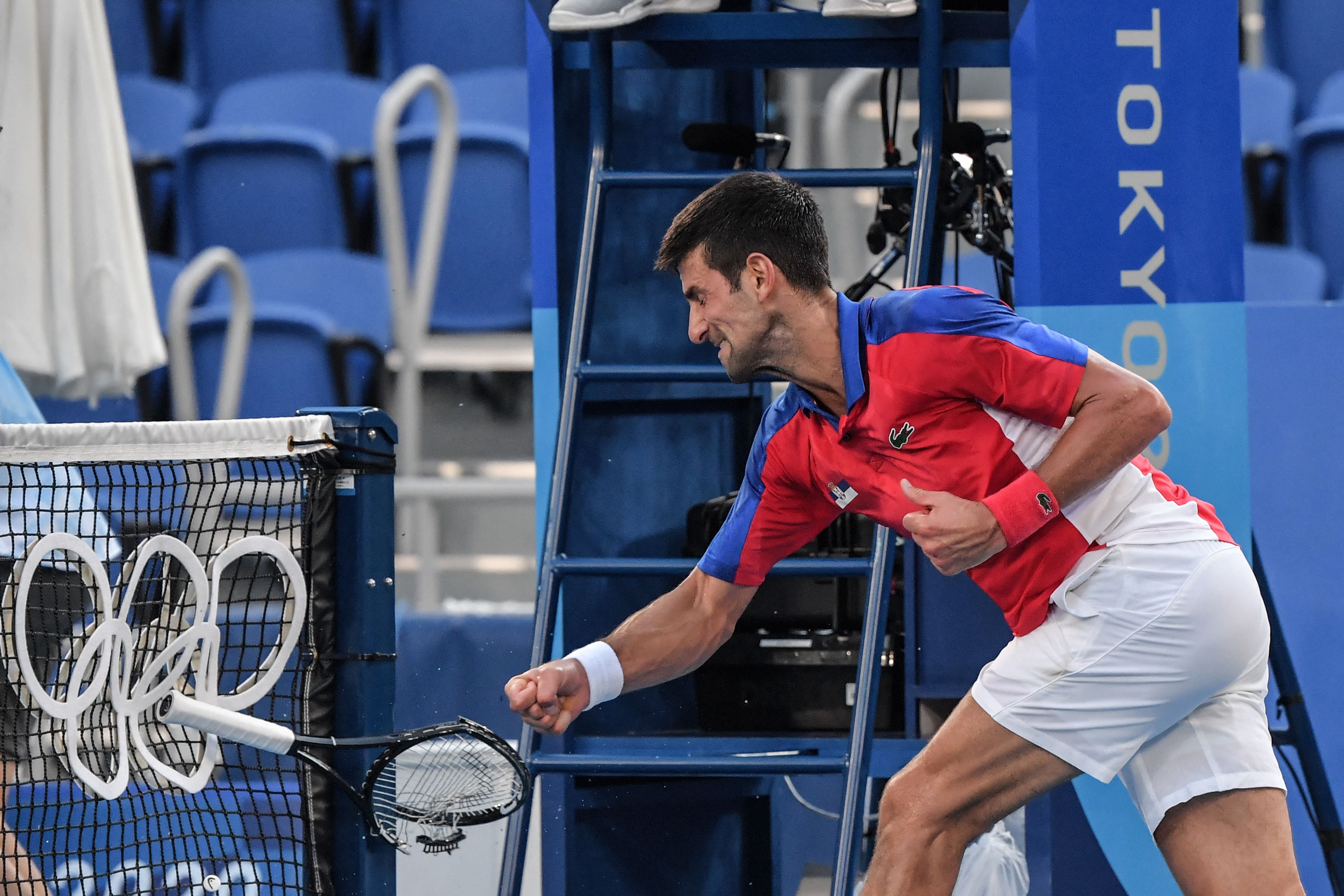 Djokovic smashes a racket after throwing one into the stands