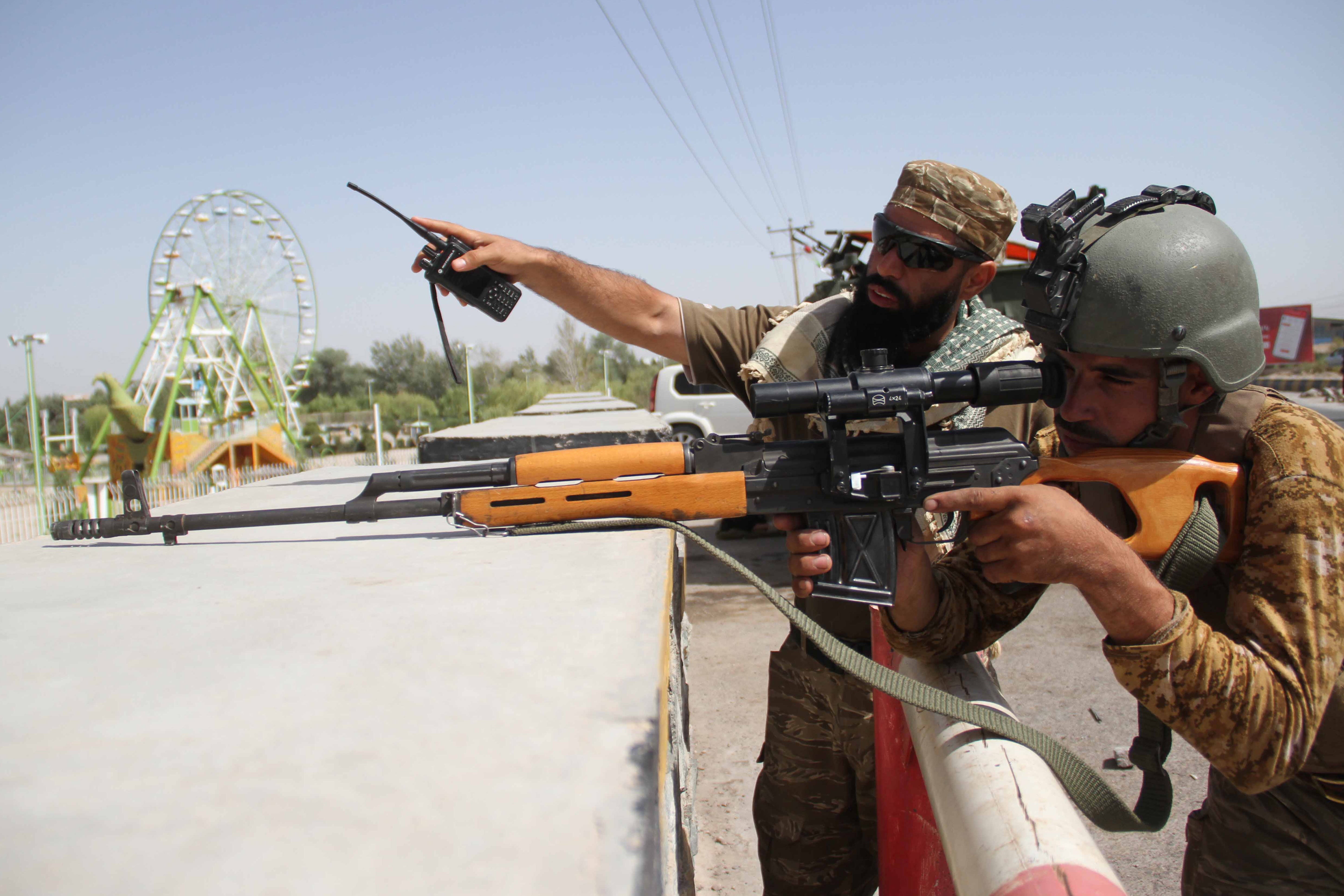 Security officials at a roadside check point in Herat, one of three Afghan cities that could fall to the Taliban