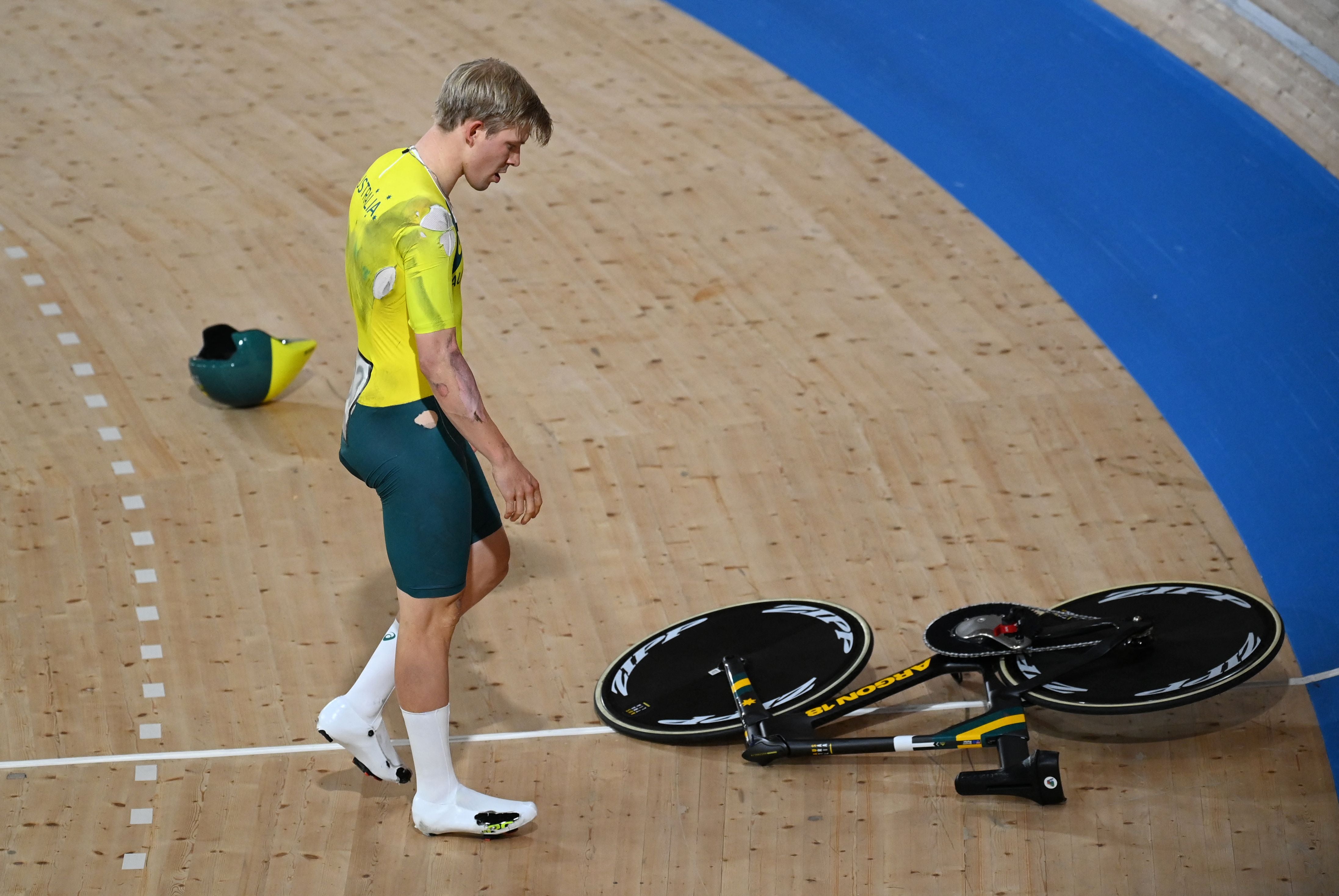 Alex Porter looks at his bicycle after crashing