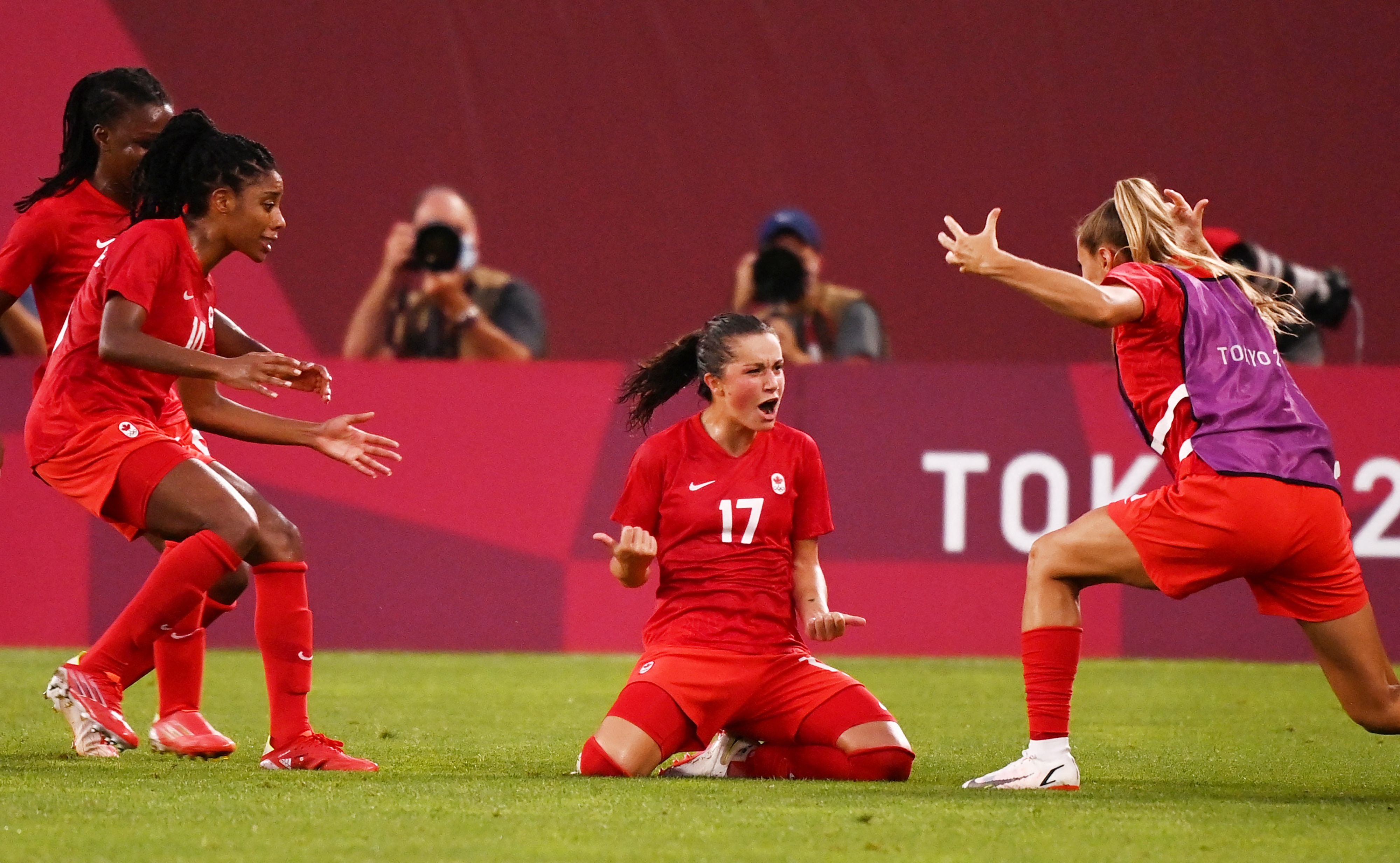 Jessie Fleming celebrates with teammates after scoring