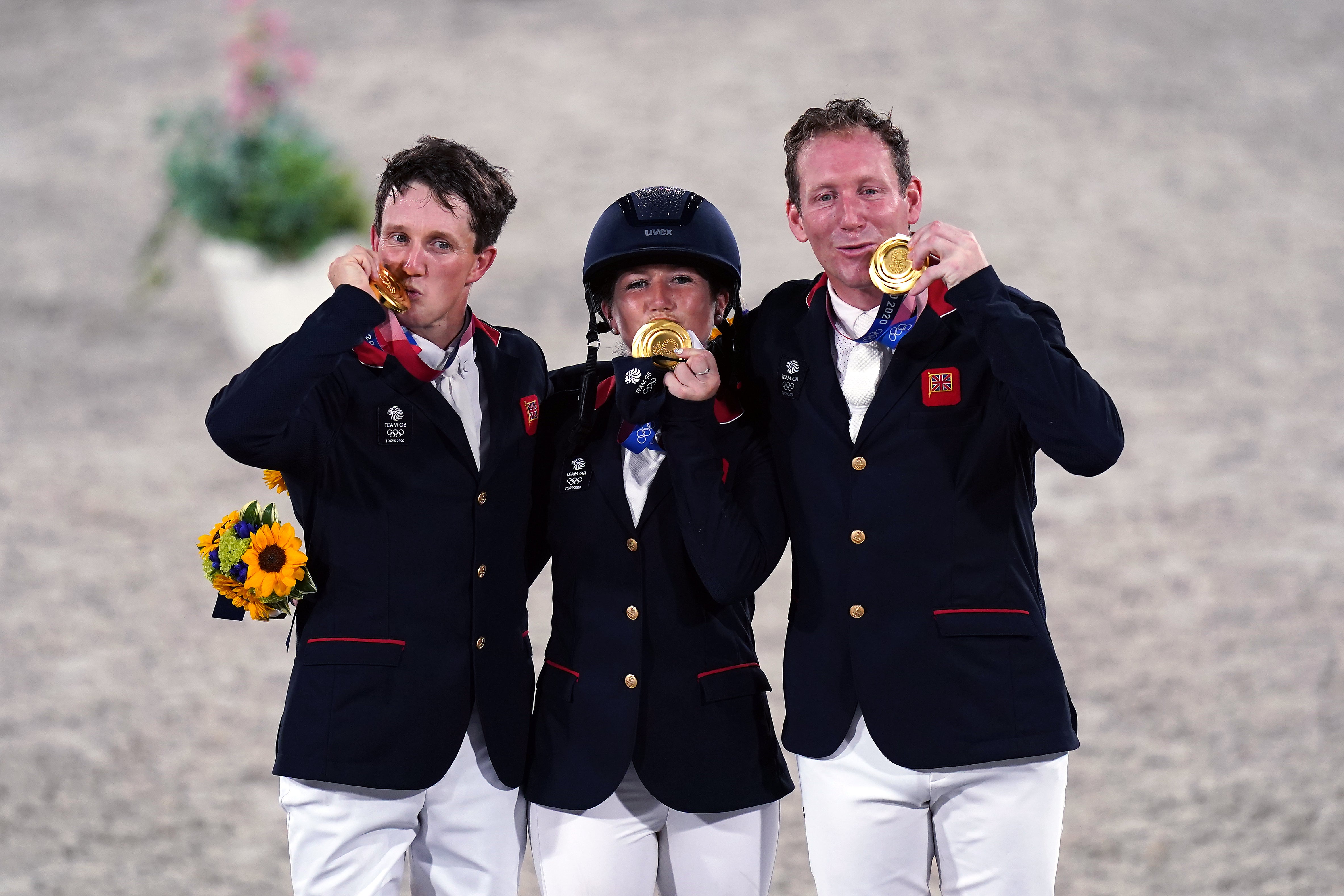 Laura Collett, Tom McEwen and Oliver Townend celebrate their gold medals (Adam Davy/PA)