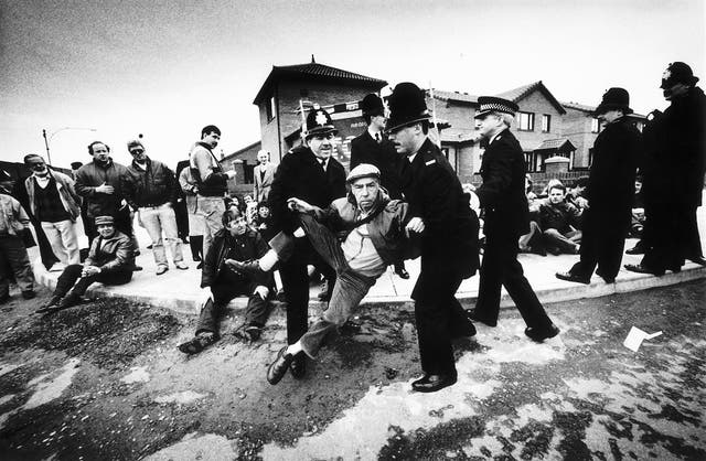 <p>A peaceful demonstrator being removed away from where Prime Minister Margaret Thatcher was due to arrive to visit the Eldonian Housing Estate in Liverpool during her tour of the North West in 1989 </p>