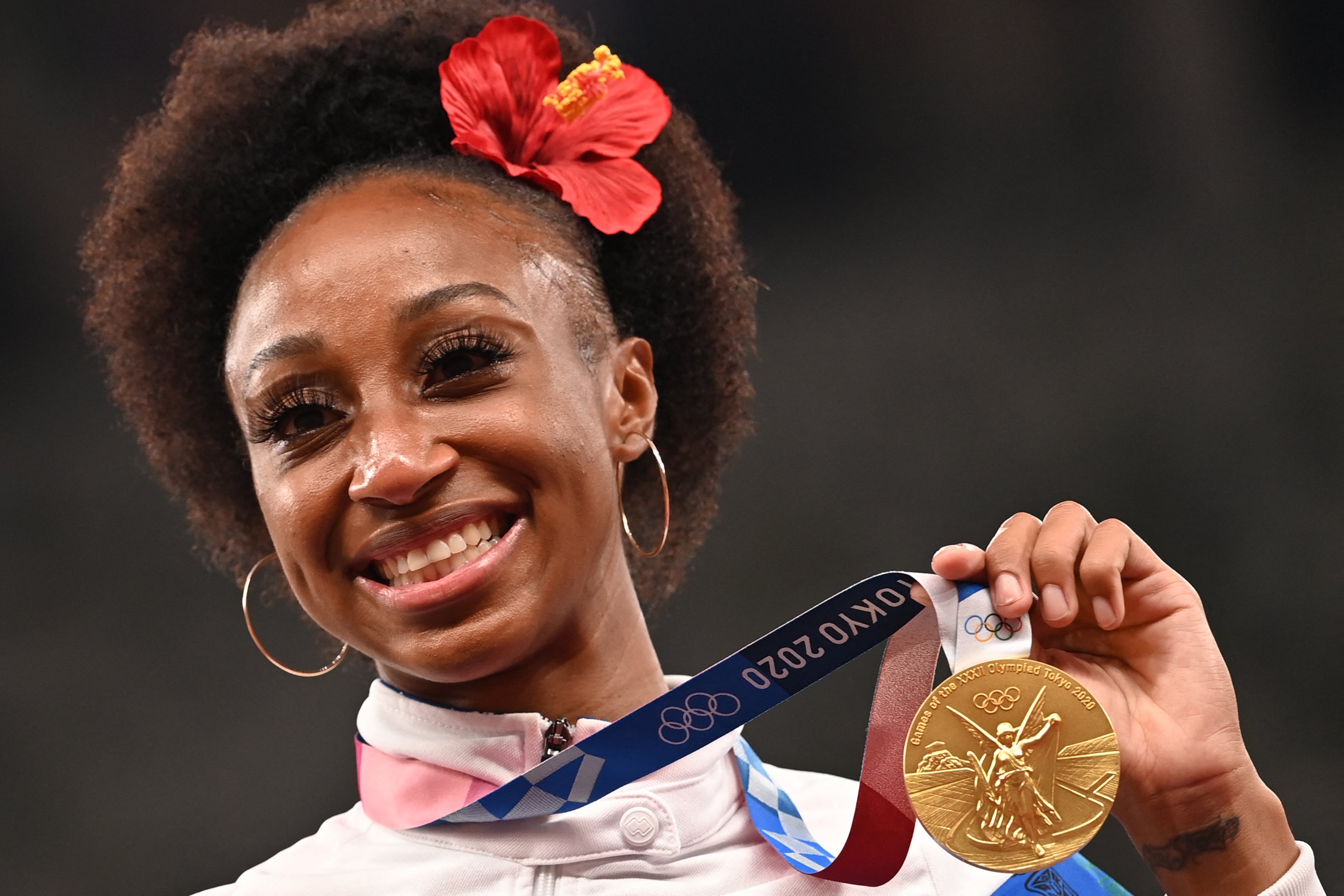 Gold medalist Puerto Rico's Jasmine Camacho-Quinn poses on the podium for the women's 100m hurdles final during the Tokyo 2020 Olympic Games at the Olympic Stadium in Tokyo on August 2, 2021