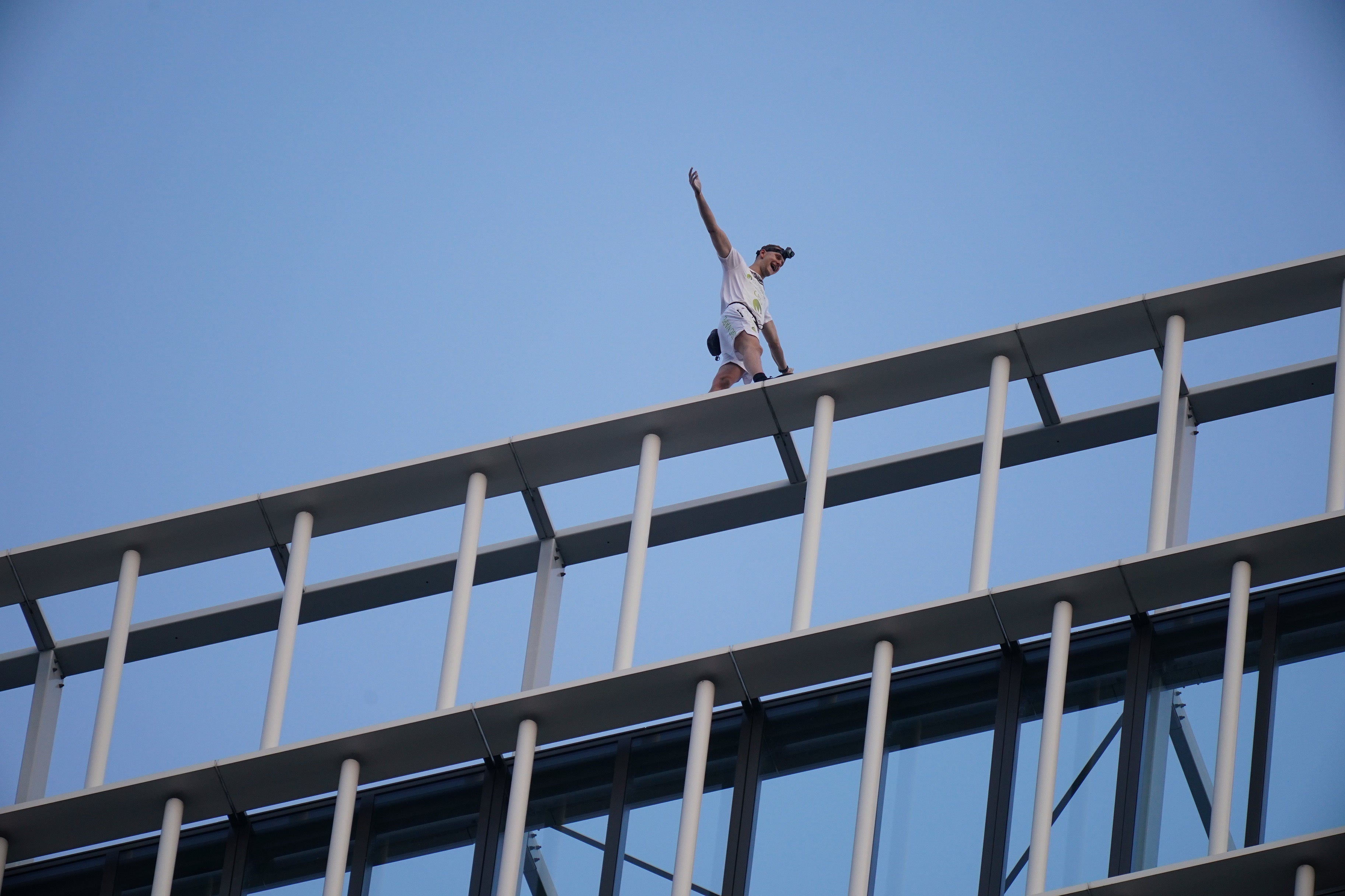 File: Free-solo climber George King-Thompson walks along the top of the Stratosphere Tower building, a 36-storey residential tower block in Stratford, east London