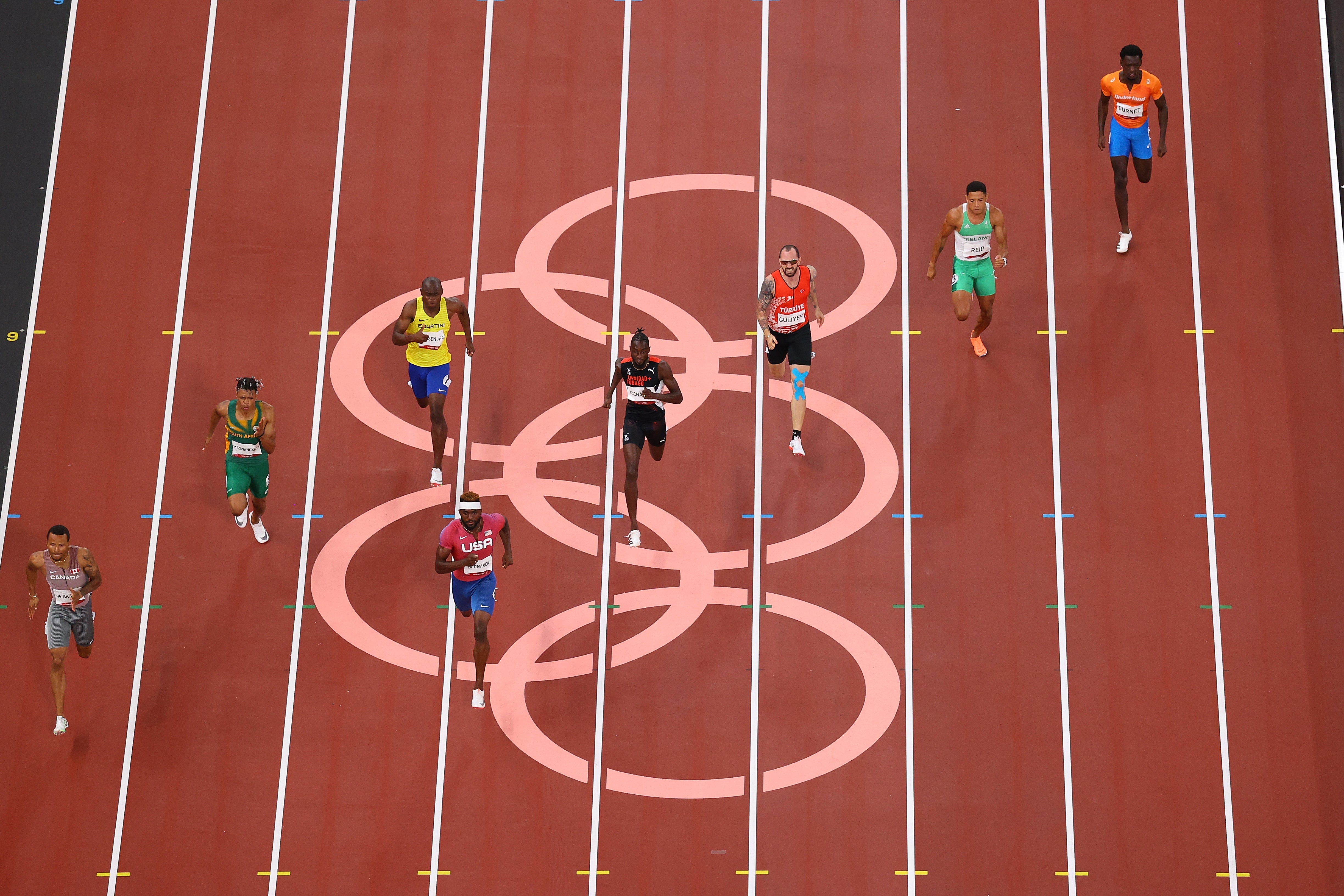 Andre de Grasse (far left) clinches victory in the last semi-final