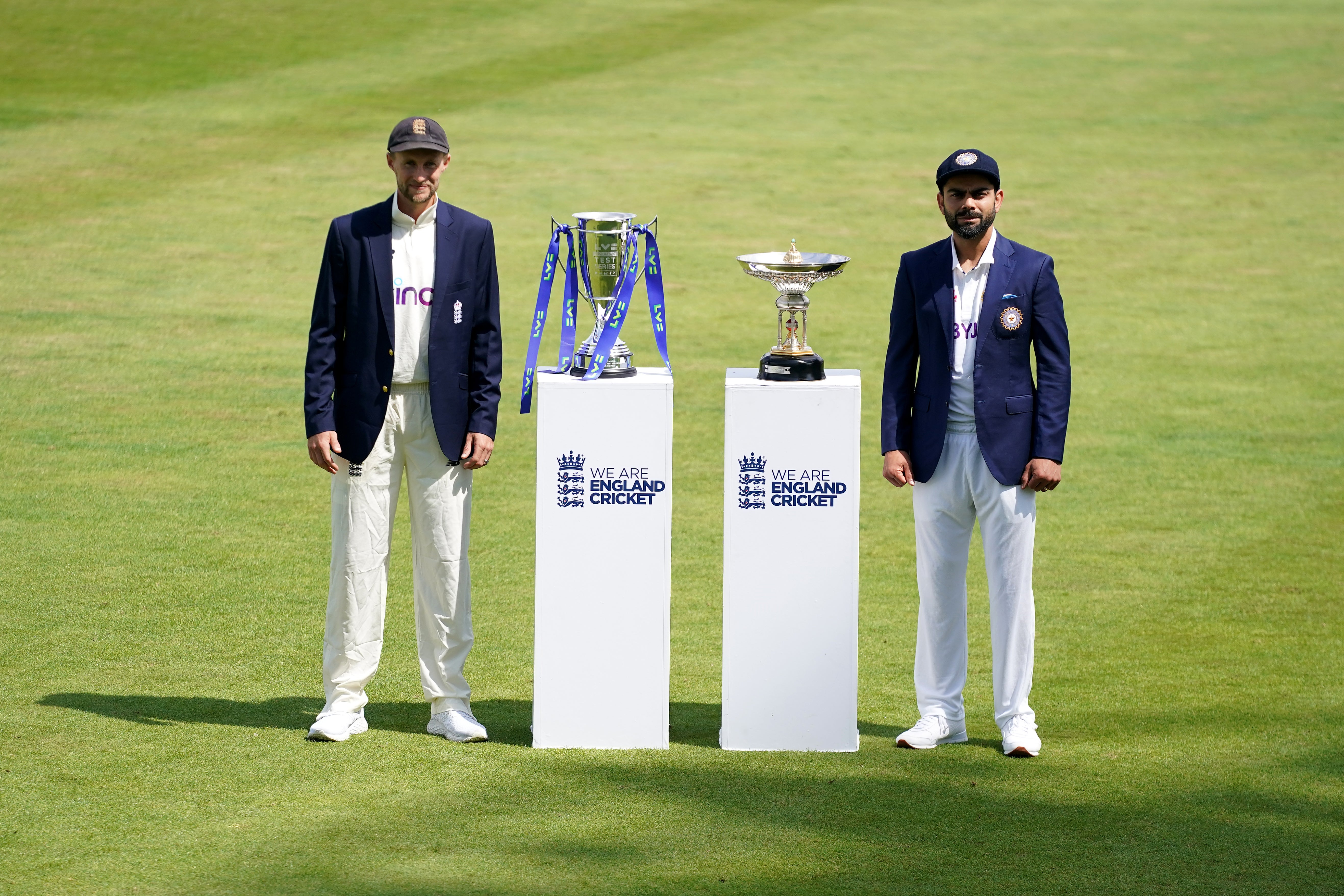 England’s Joe Root, left, and India’s Virat Kohli pose with the series trophies (Zac Goodwin/PA)