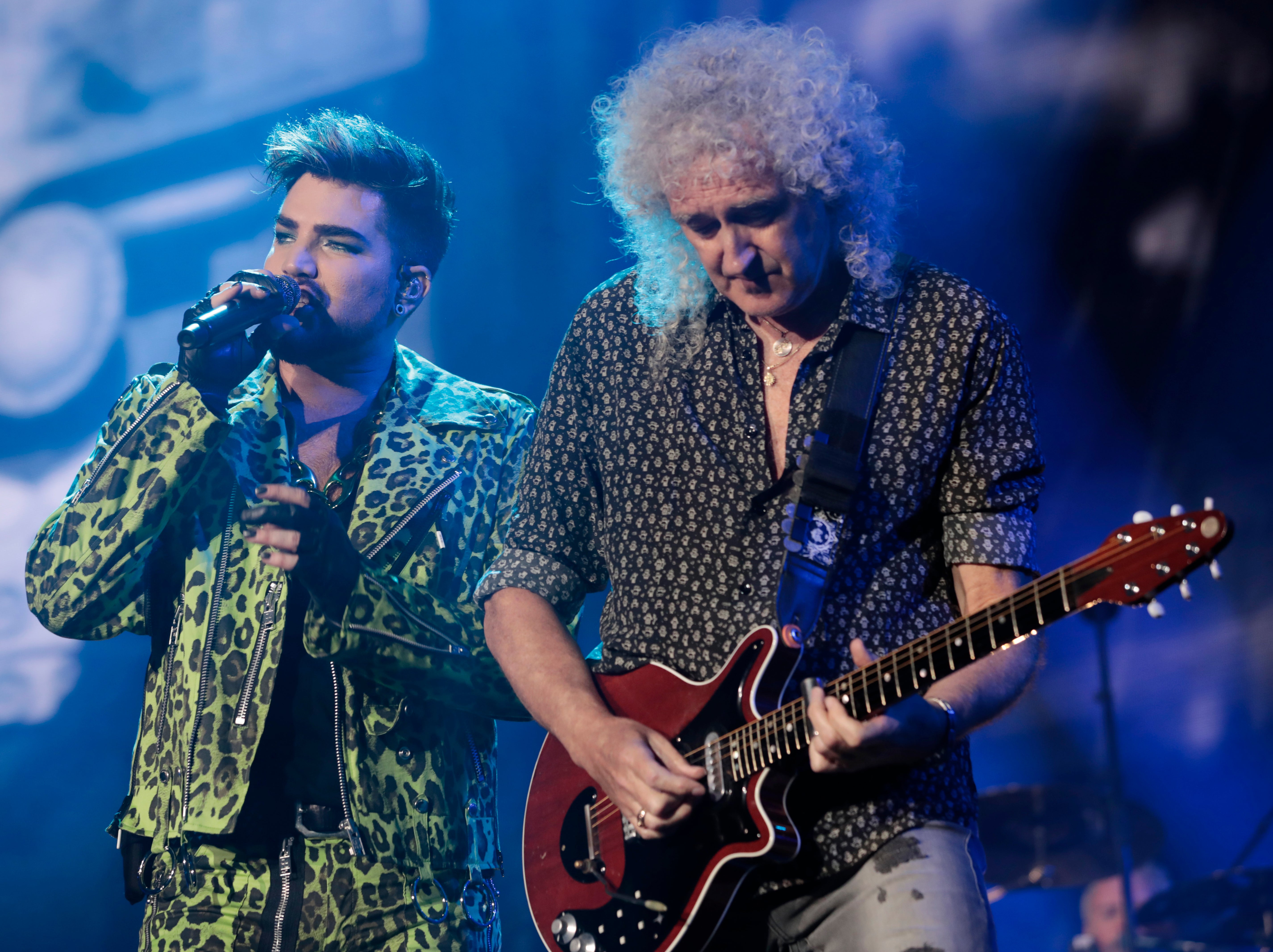 Adam Lambert performing with May at a benefit concert in 2020