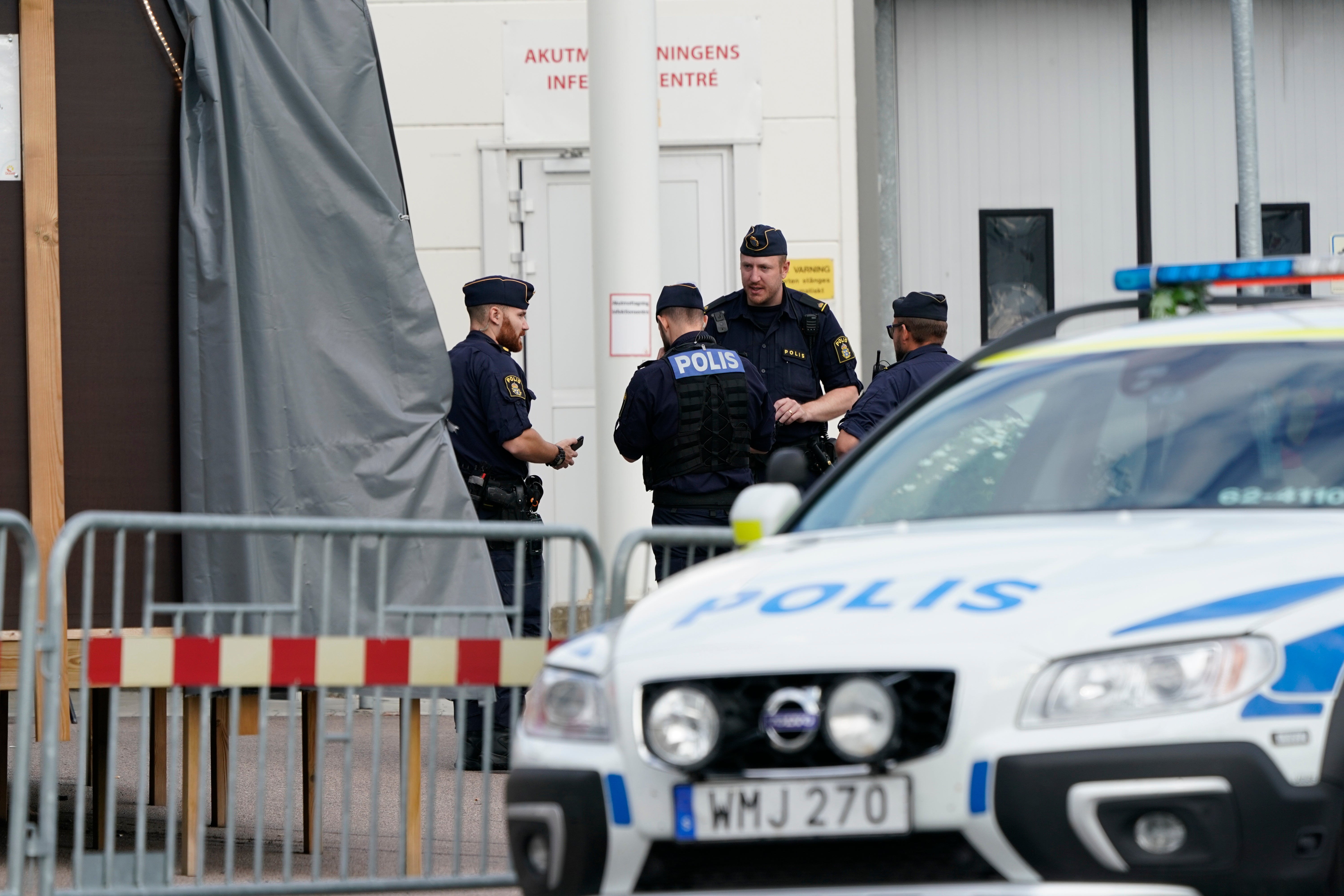 Police monitor the area at the scene of a shooting in Kristianstad