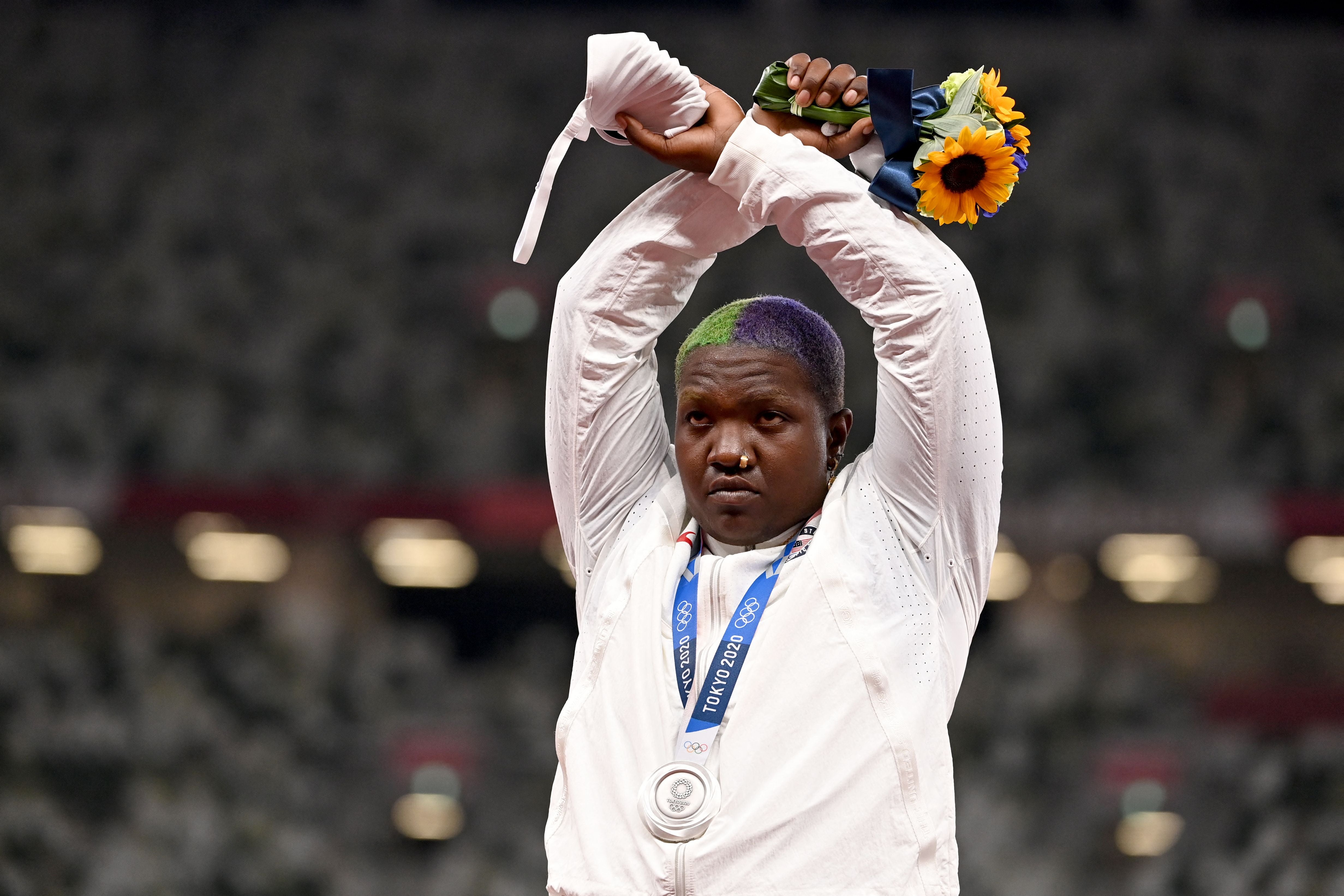 Second-placed USA's Raven Saunders gestures on the podium with her silver medal after competing the women's shot put event during the Tokyo 2020 Olympic Games at the Olympic Stadium in Tokyo on August 1, 2021.