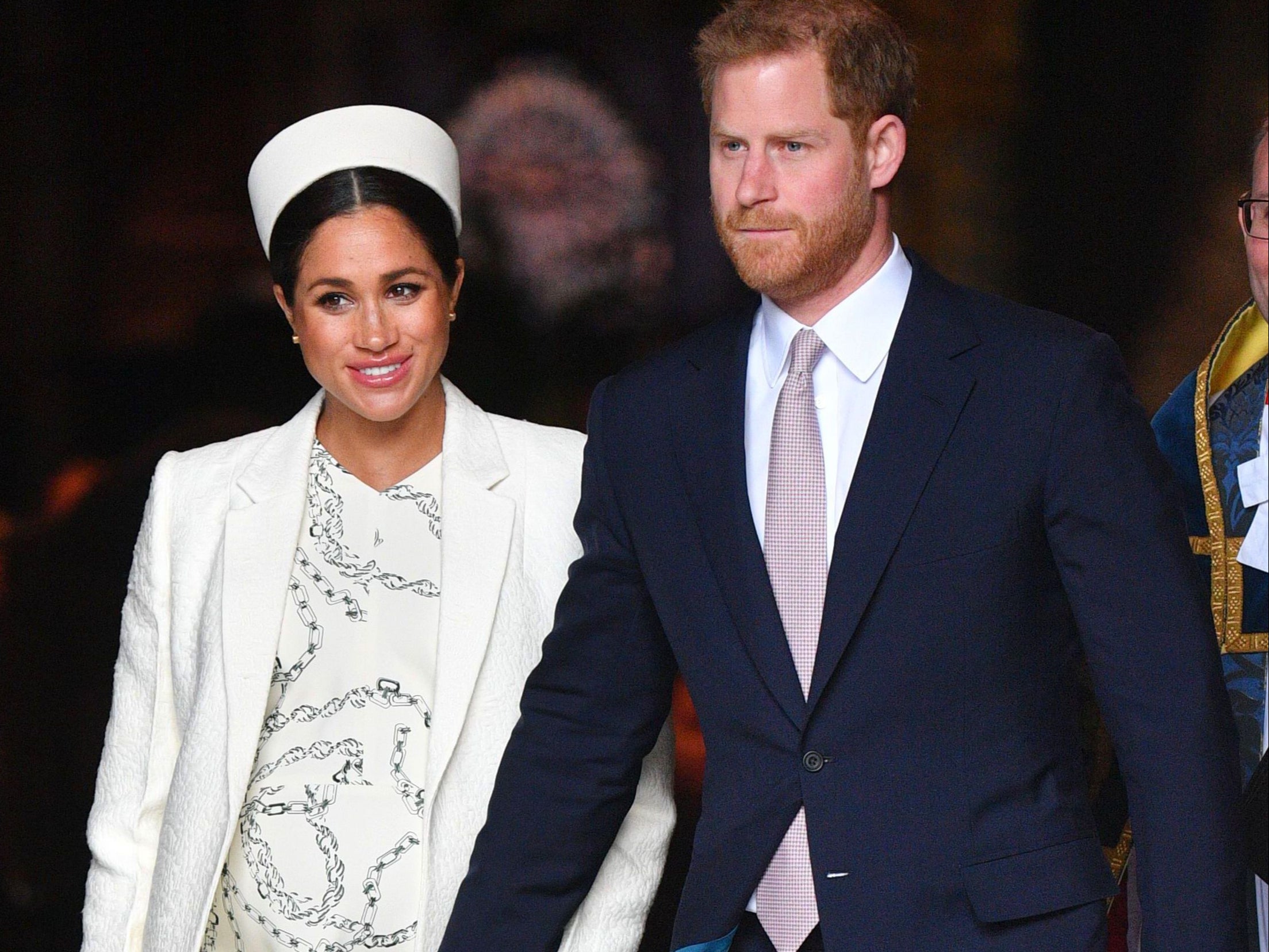 Meghan Markle and Prince Harry walk hand-in-hand