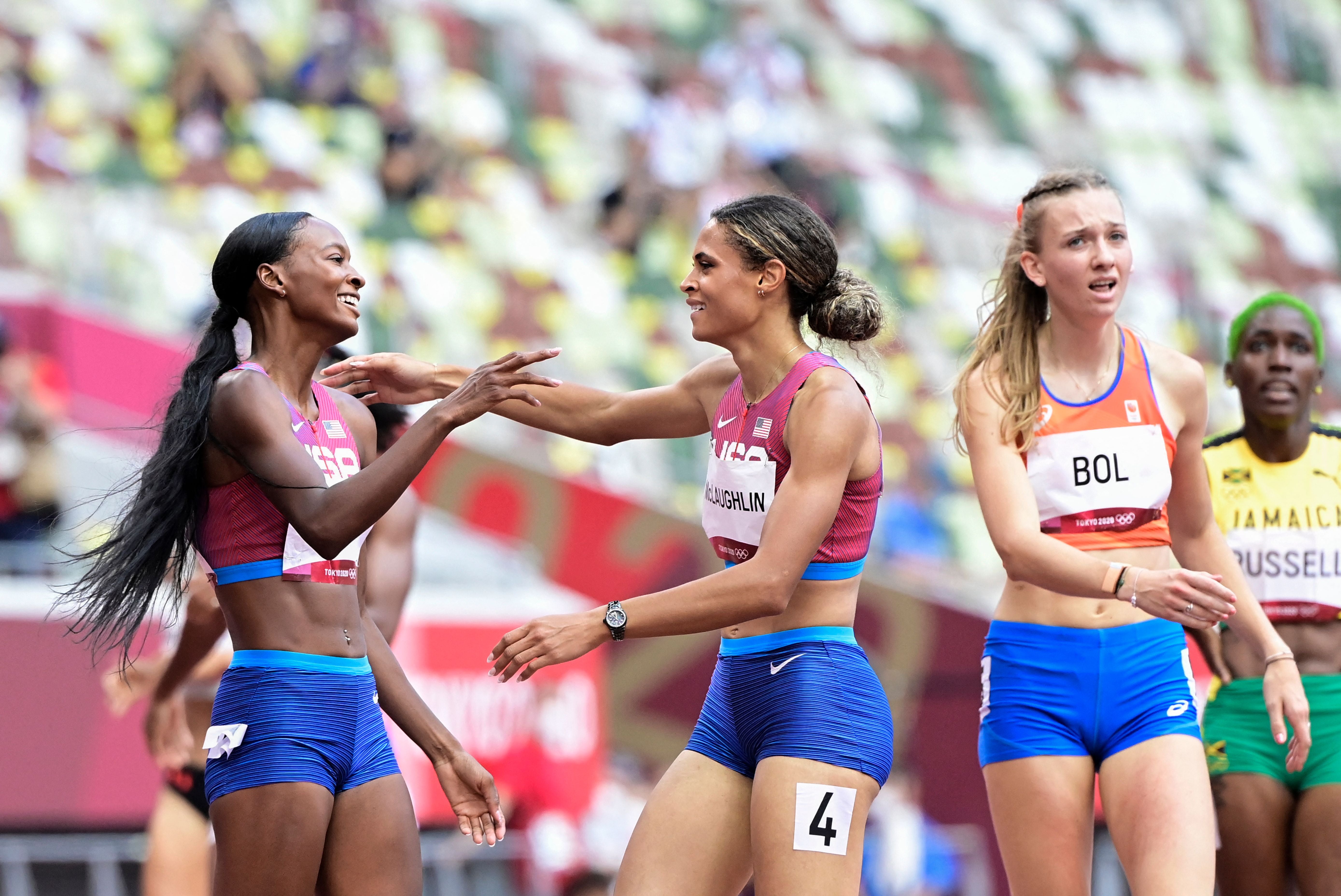 Sydney Mclaughlin reacts after winning the women’s 400m hurdles final with Dalilah Muhammad as Femke Bol looks on