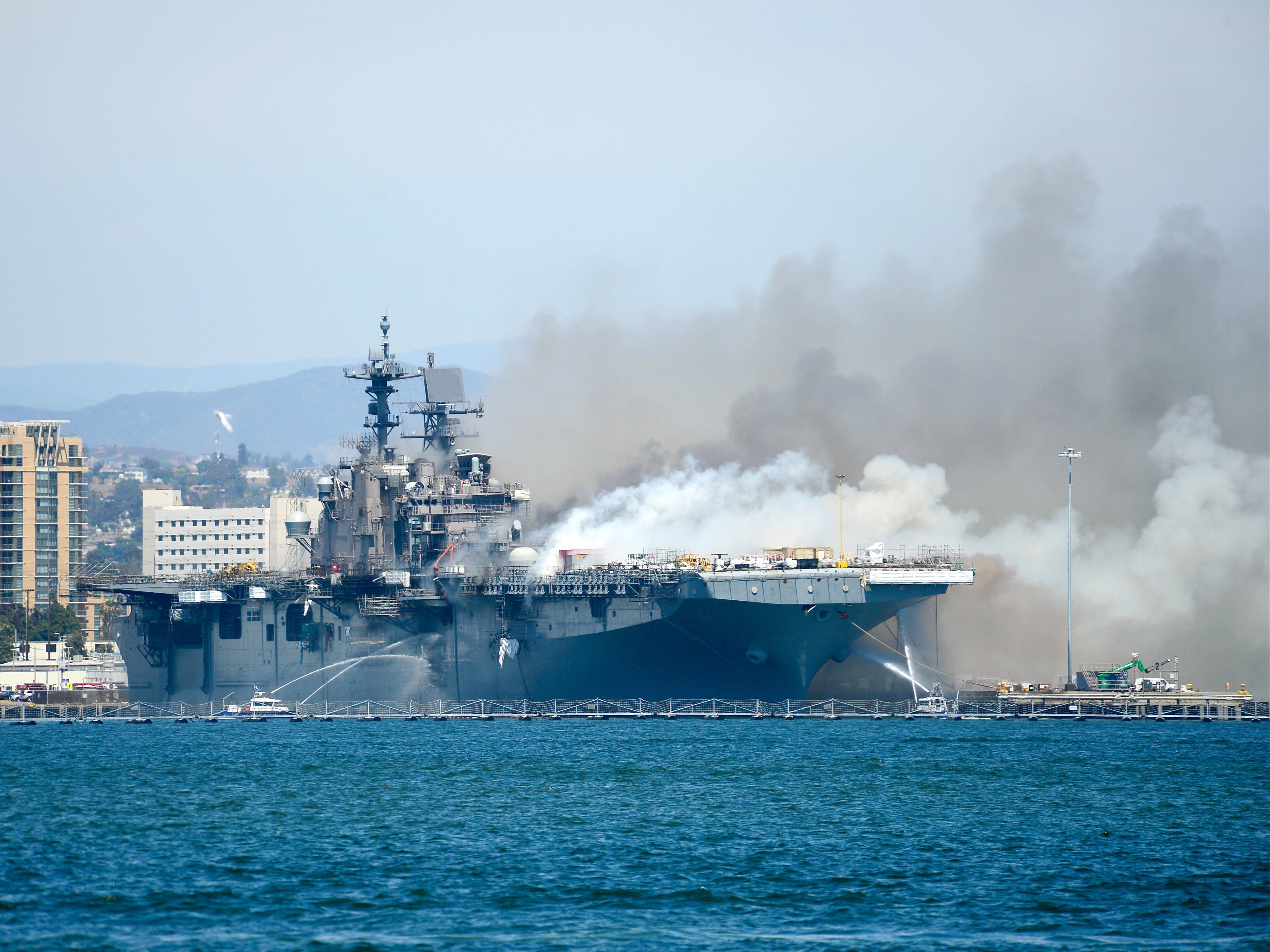 Port of San Diego Harbor Police Department boats combat a fire aboard the amphibious assault ship USS Bonhomme Richard (LHD 6) at Naval Base San Diego, July 12, 2020.